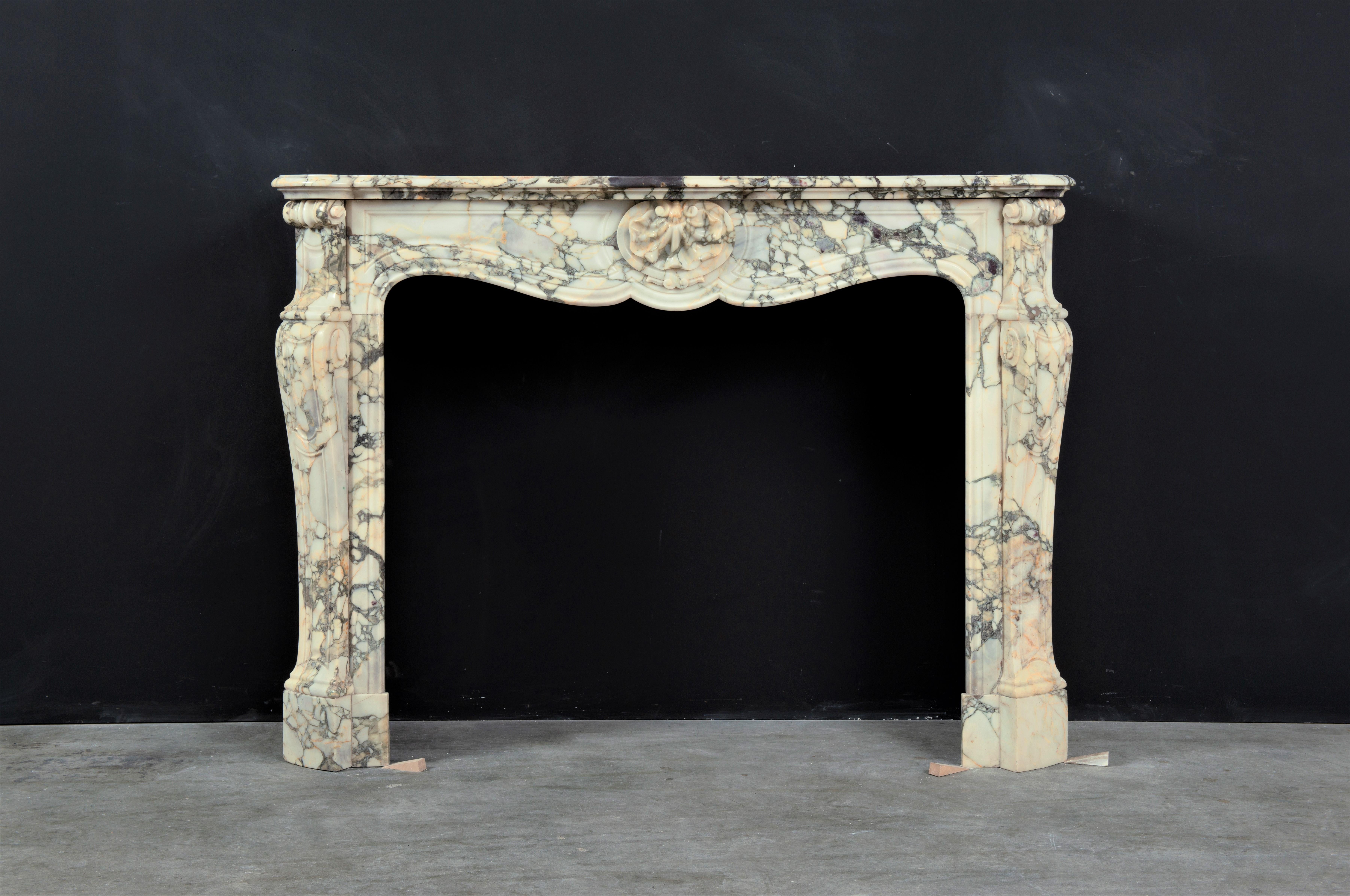 Lovely French Louis XV Fireplace in beautiful breche marble.
This super decorative and perfect sized mantel is suitable for any kind of interior.

It comes with its original 