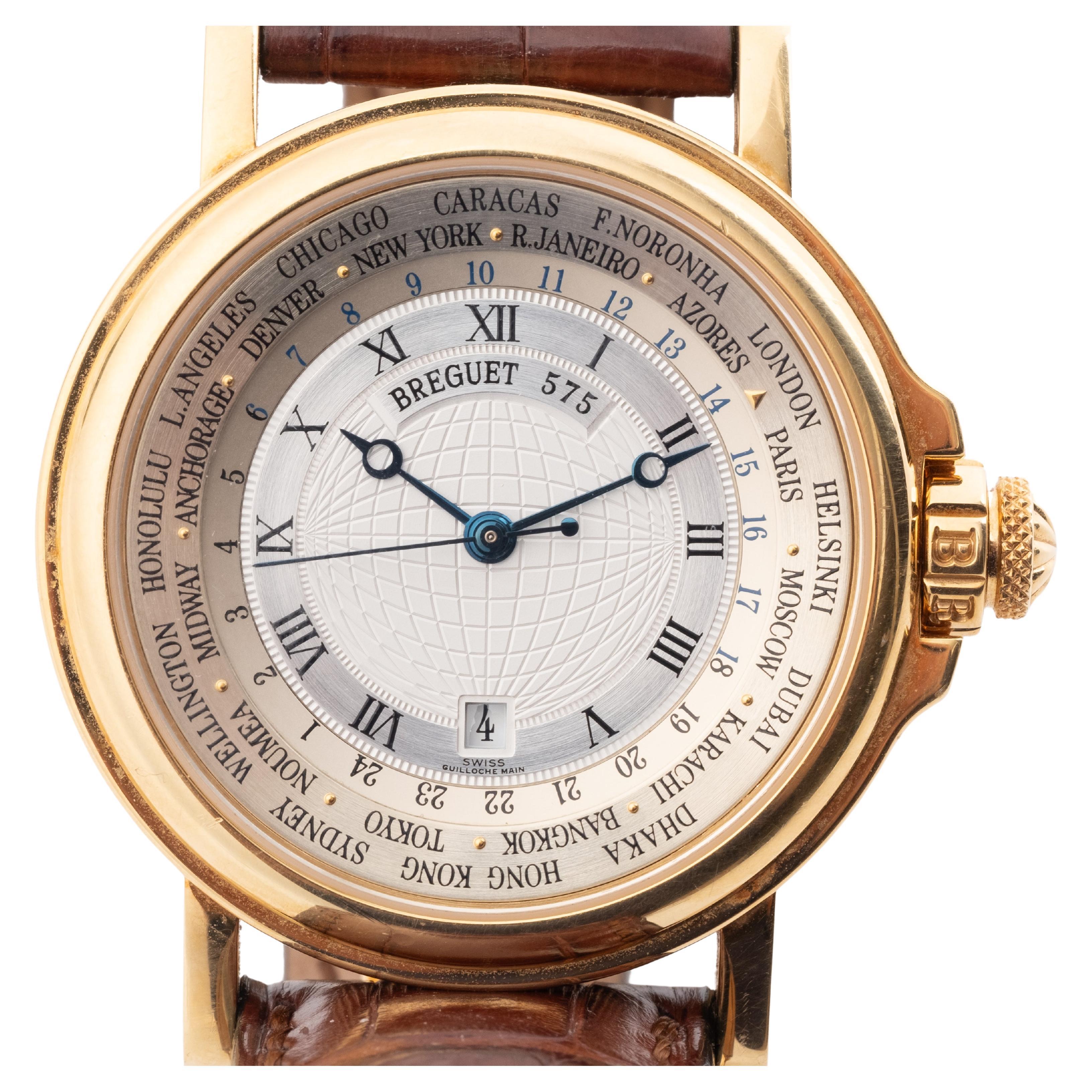This wristwatch by Breguet, model Marine,World Time  reference 3700, dates back to around the year 2000. It features a 25-jewel Cal.563 automatic winding movement. The dial is silver, adorned with an engraved center reserve and an outer rotating