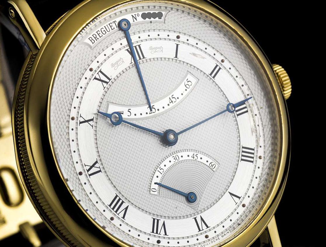 An 18k Yellow Gold Classique Gents Wristwatch, silvered gold dial hand engraved on a rose engine, an off-centred chapter ring with roman numerals, retrograde seconds at 6 0'clock, power reserve indicator at 12 0'clock, an 18k yellow gold fixed