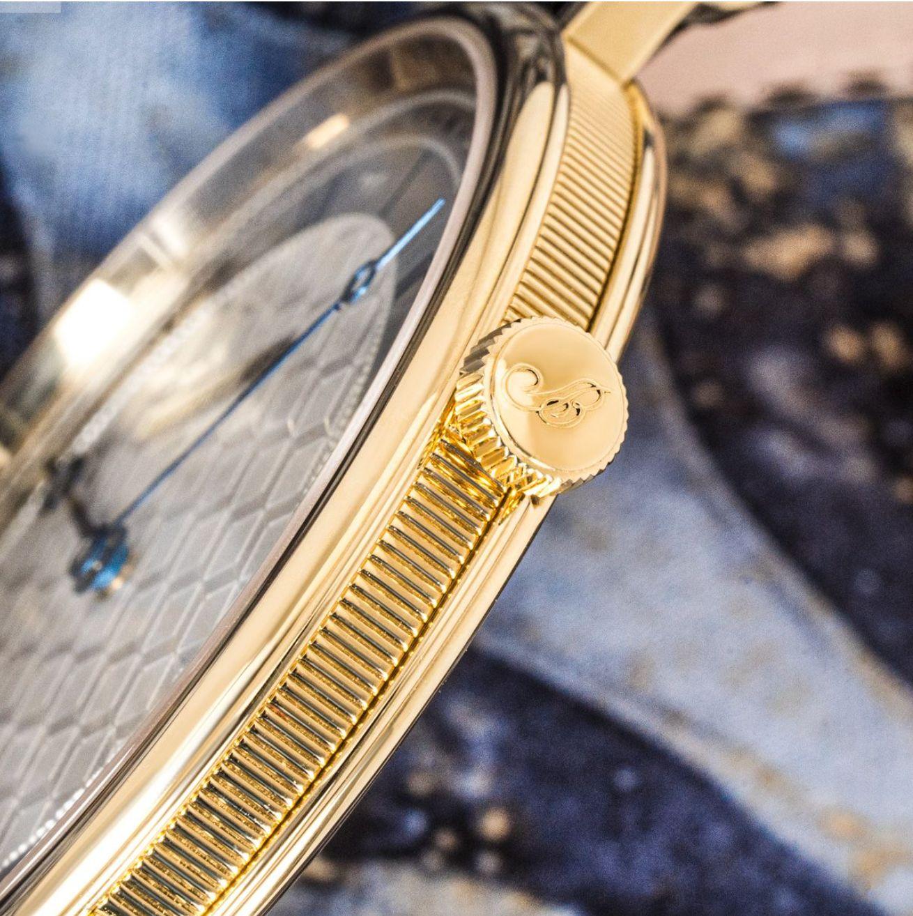 A 41mm extra thin Classique wristwatch by Breguet, crafted in yellow gold. Featuring a silver guilloche dial with blued steel hands and a yellow gold bezel. Fitted with a sapphire glass and a self-winding movement which can be seen by the exhibition