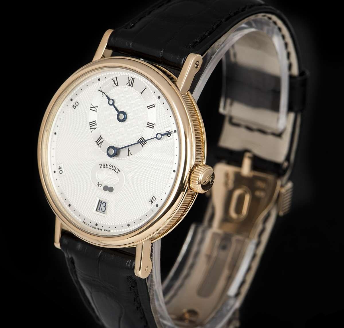 An 18k Rose Gold Classique Regulator Gents Wristwatch, silver dial hand engraved on a rose engine, silver off-centre chapter ring with roman numerals indicating the hour, date at 6 0'clock, a silver chapter ring on the outer edge of the dial