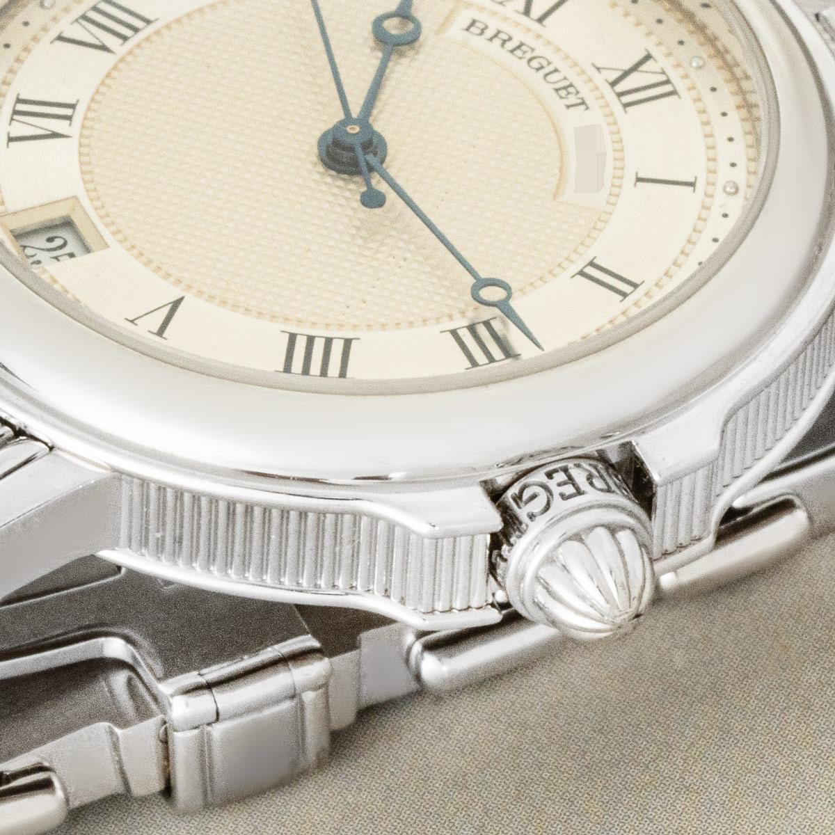 A Breguet Horloger De La Marine wristwatch in white gold. Featuring a silvered guilloche dial with Roman numerals and a date display at 6 o'clock. The watch also features blued steel Breguet hands and a fixed white gold bezel.

The white gold