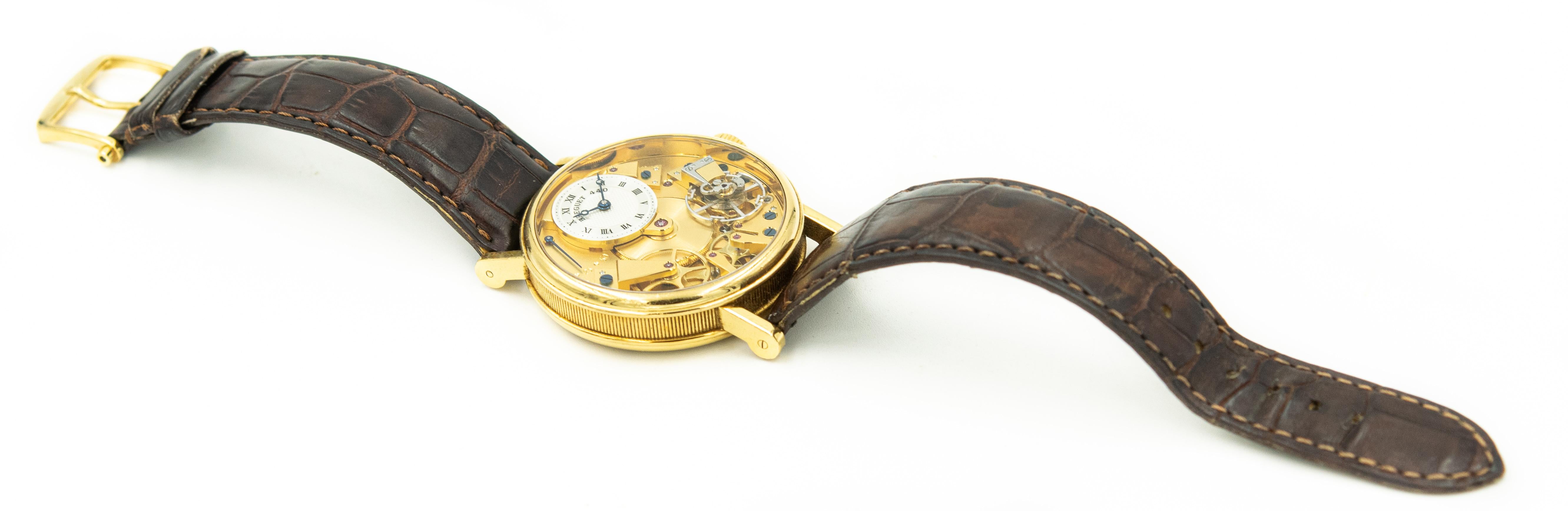 Breguet La Tradition Ref. 7027 Serial # 440 V 18k yellow gold semi-skeletonized wristwatch with power reserve indication.
Dial: gilt, semi skeletonized
Caliber: cal. 507DR manual winding, 34 jewels
Movement number:  0603015
Case: 18K yellow gold,