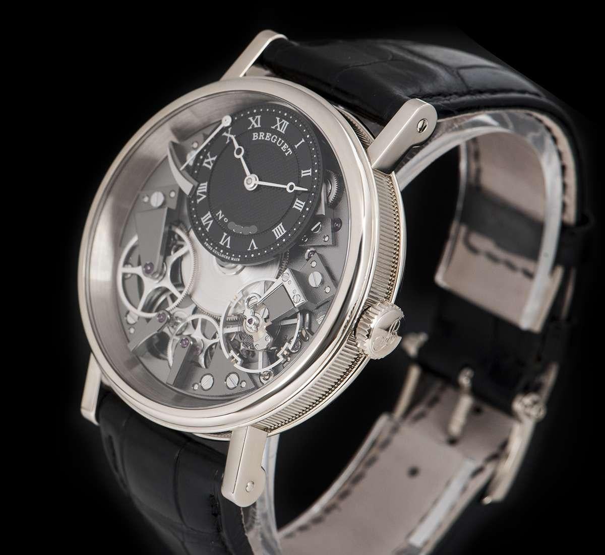 An Unworn 18 White Gold La Tradition NOS Gents Wristwatch, open worked dial with an off-centred black dial hand engraved on a rose engine with roman numerals, power reserve indicator at 11 0'clock, a fixed 18k white gold bezel, an original black