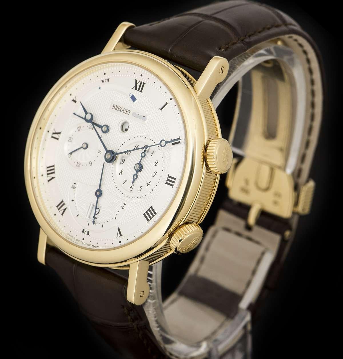 An 18k Yellow Gold Le Reveil Du Tsar Gents Wristwatch, silvered guilloche dial hand engraved on a rose engine with roman numerals and a secret signature on chapter ring, alarm indicator at 3 0'clock, date and small seconds at 6 0'clock, second time