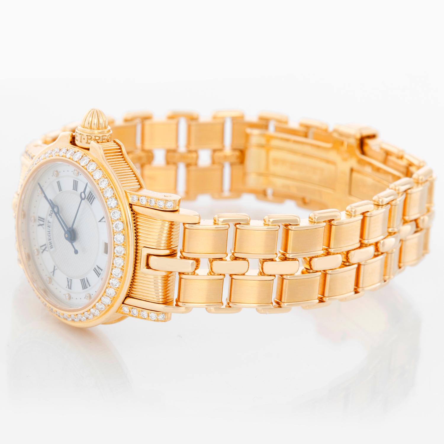 Breguet Marine Automatic Ladies 18k Yellow Gold Watch 8401BA/52/A40.DD00 - Automatic winding. 18 yellow gold case with diamond bezel and diamond lugs (26mm diameter). Mother of Pearl dial with a Roman numerals. 18K yellow gold Breguet bracelet