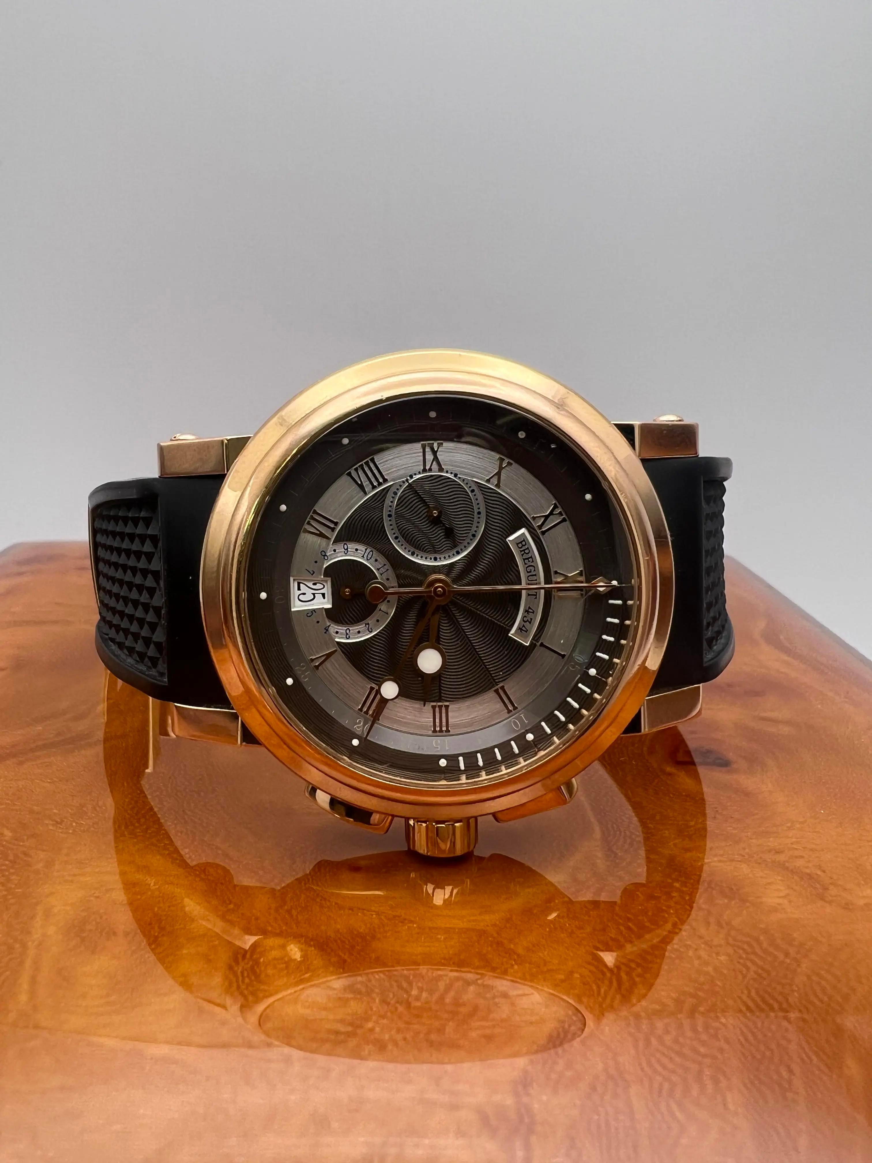 Breguet Marine 2 Chronograph 5827BR/Z2/5ZU, featuring a luxurious 42mm 18k rose gold case and a distinctive black rhodium guilloché dial. The dial is elegantly accented with applied rose gold Roman numerals, luminous hands, and chronograph
