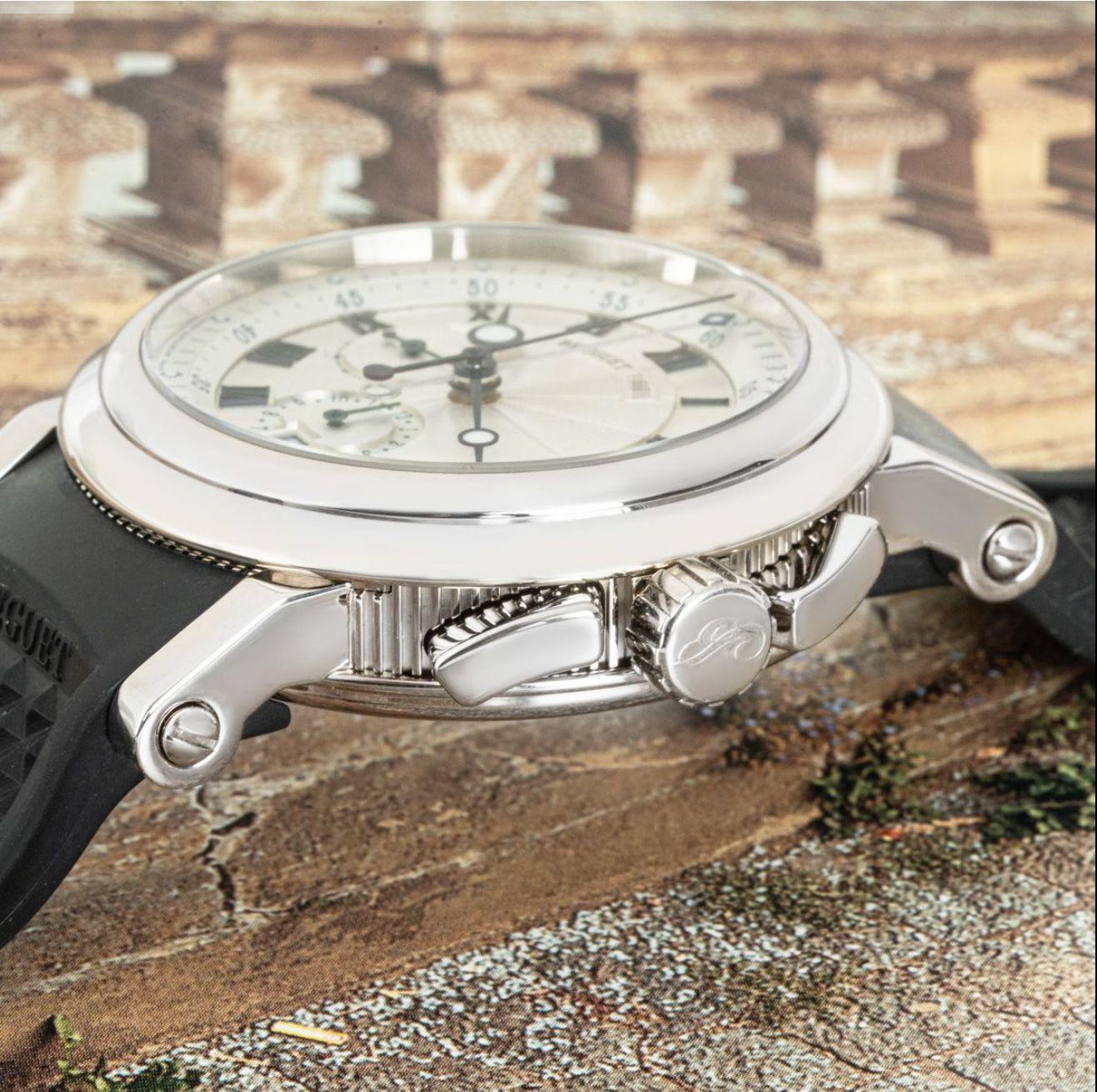 A men's 42mm Marine wristwatch crafted in white gold by Breguet. Featuring a distinctive silver dial with applied roman numerals, blued steeled Breguet hands, two chronograph counters and a date aperture. Complementing the dial is a smooth fixed