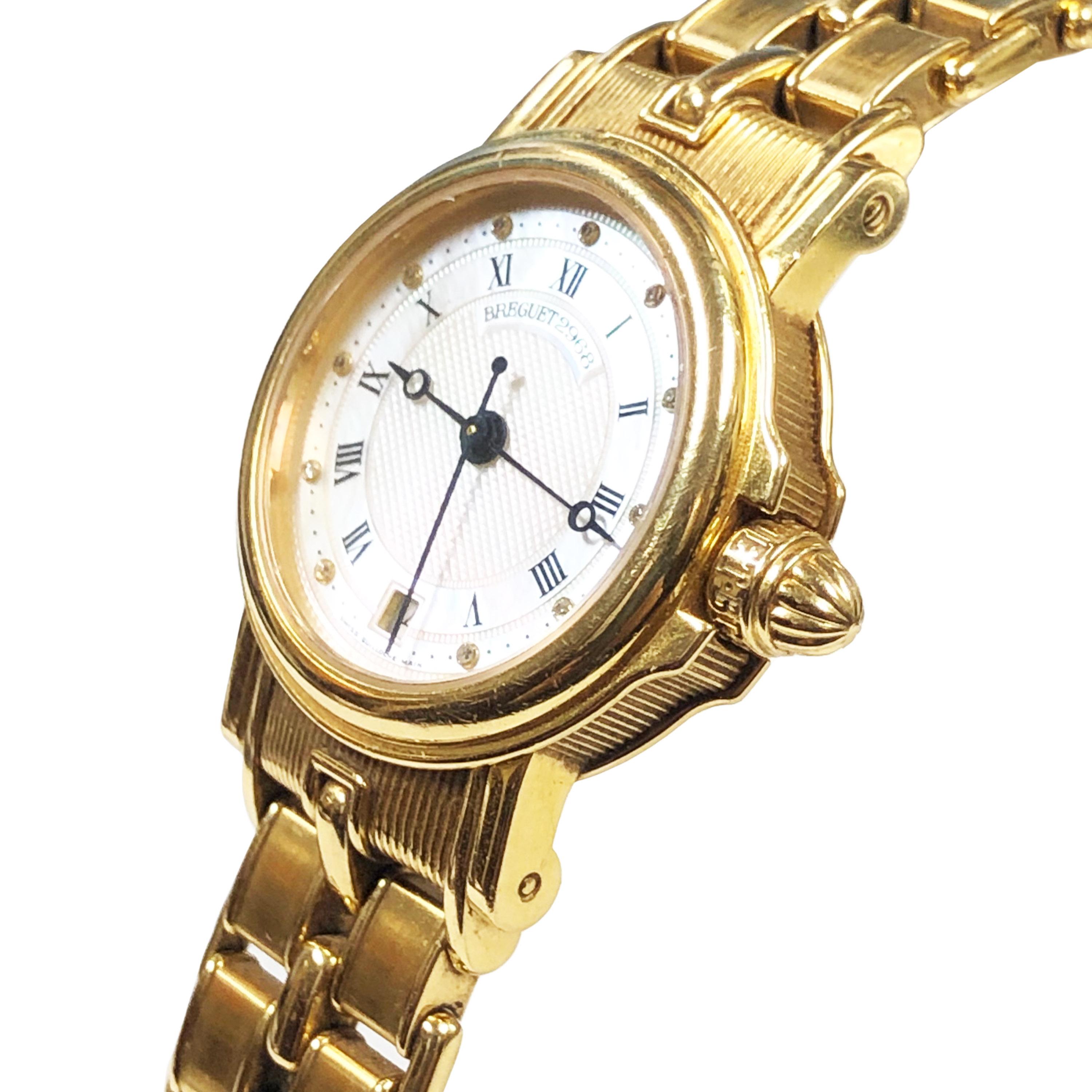 Circa 2005 Breguet Marine collection Ladies Wrist watch, 26 MM Diameter 18K yellow Gold 7 MM thick Water Resistant Case.  Automatic, self winding movement, Mother of Pearl Dial with Diamond set markers and a sweep seconds hand. 1/2 inch wide 18K