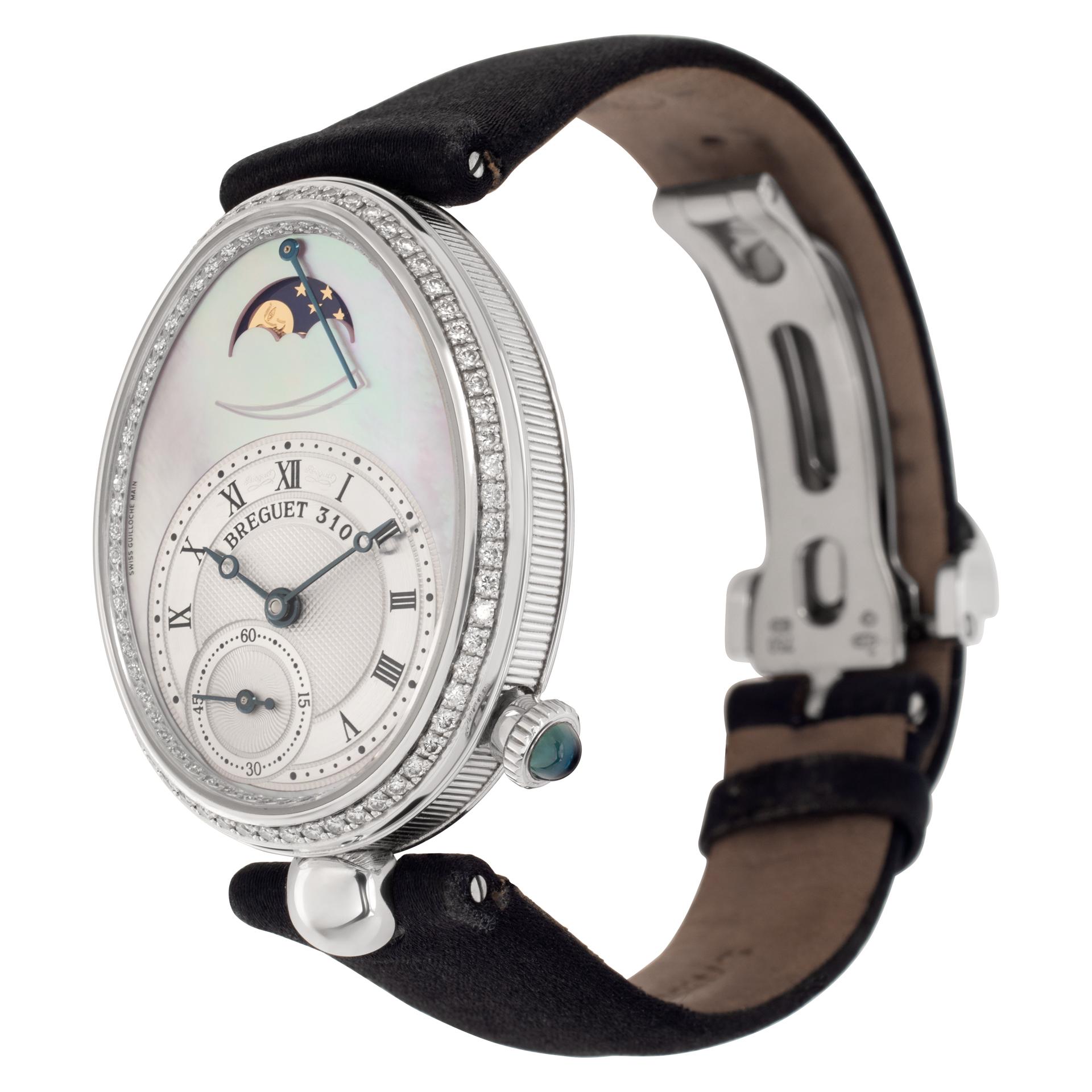Breguet Reine de Naples in 18k white gold with diamond bezel & chapter ring set on mother of pearl dial on a black suede strap with diamond set white gold deployant buckle. Auto w/ subseconds, moonphase and power reserve. 29 mm x 36. mm case size.