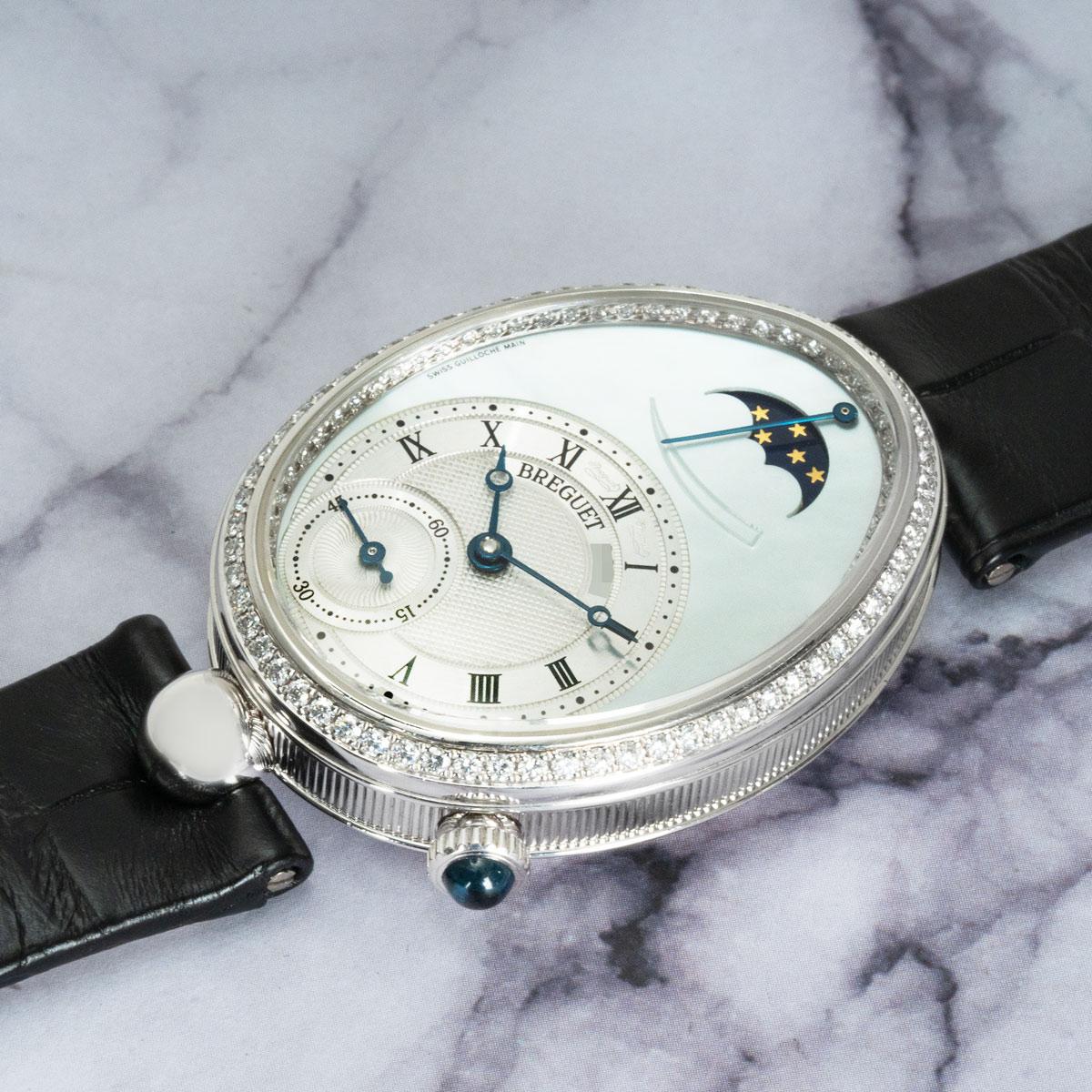 A white gold Reine de Naples from Breguet. Features a mother of pearl dial with a smaller silvered dial featuring a Breguet signature either side of XII. The dials feature blued steel Breguet hands, a small seconds display and a power reserve and