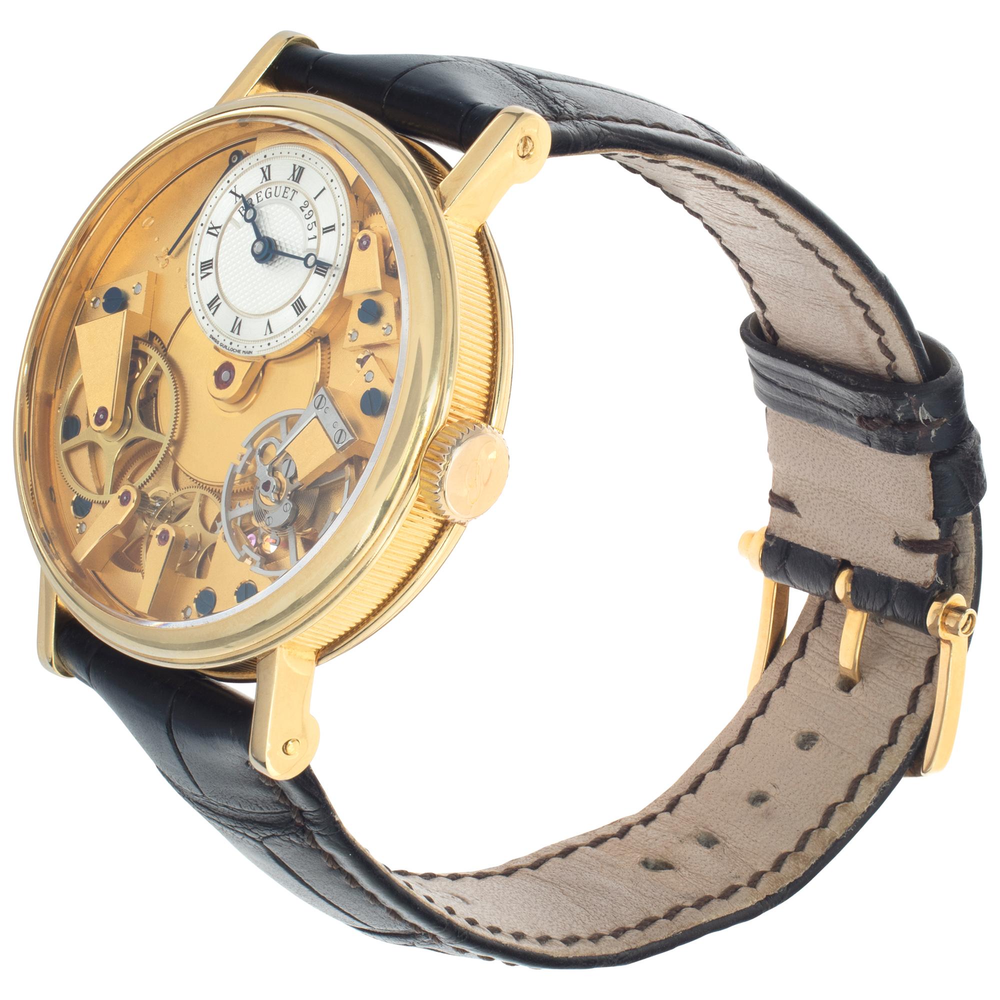 Breguet Tradition in 18k yellow gold on a black alligator strap with an 18k yellow gold Breguet tang buckle. Manual skeletonized movement. 38 mm case size. Ref 7027BA/11/9V6. Fine Pre-owned Breguet Watch.

 Certified preowned Classic Breguet