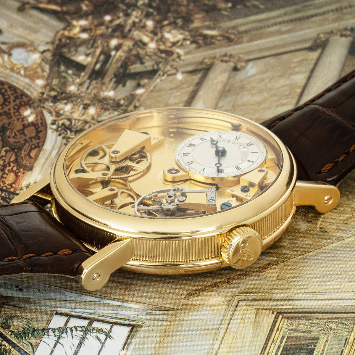 A 37mm Breguet Tradition wristwatch crafted in yellow gold. Featuring a champagne open-worked dial with an off-centred silver guilloche dial with Roman numerals, blued steel Breguet hands and a power reserve indicator.

Fitted with sapphire glass