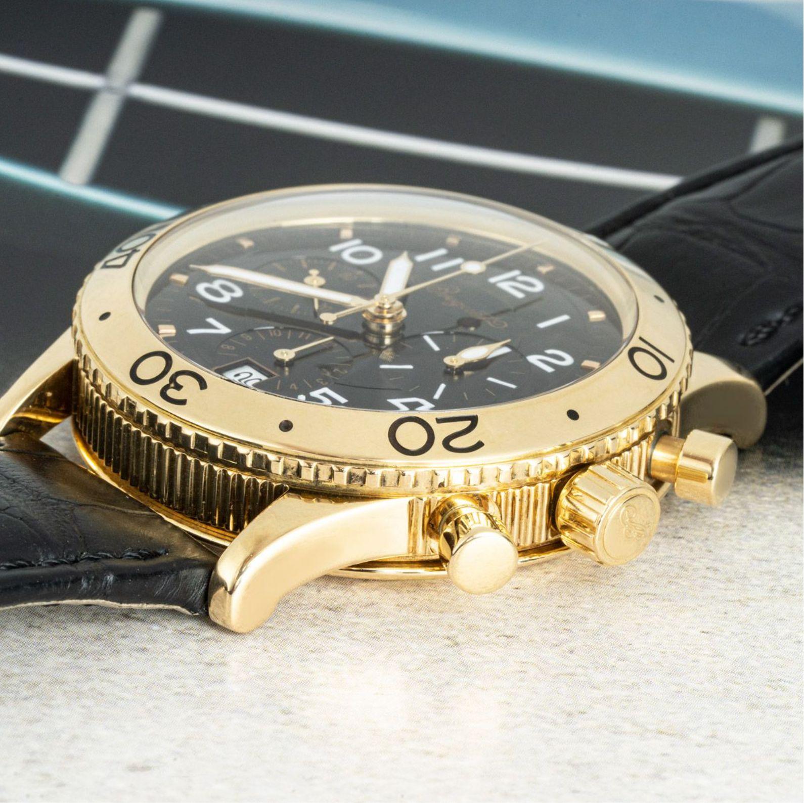 A yellow gold Type XX Transatlantique wristwatch by Breguet. Featuring a black dial with arabic numbers, a date aperture, 3 chronograph counters and a yellow gold bi-directional rotating bezel. Fitted with a sapphire glass, a self-winding automatic