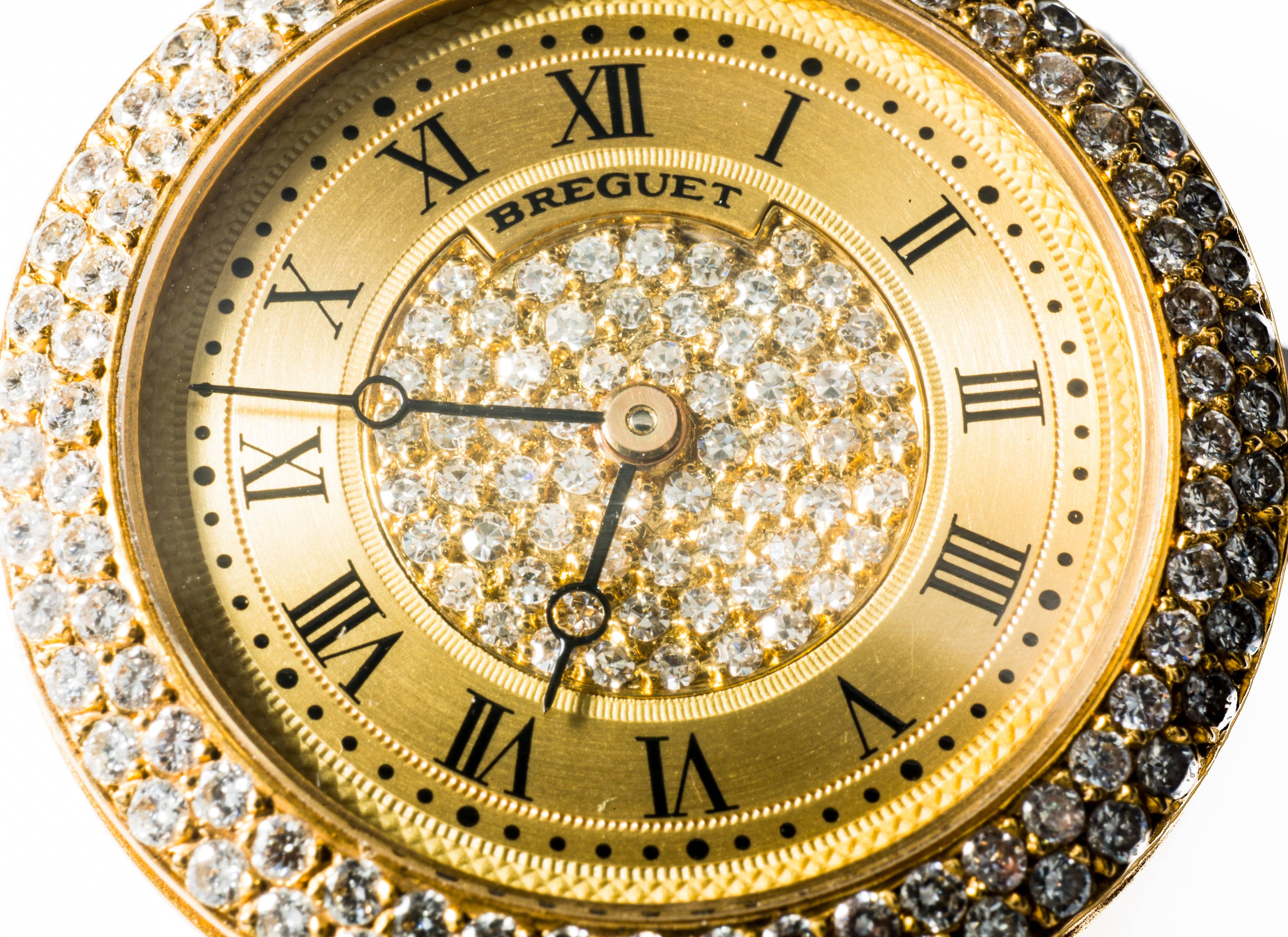 This Breguet watch in yellow gold has extra-white diamonds all around the case and a rich pavé at the centre. It's shape and design are classic and can make a beautiful pendant necklace. Dials are expressed in roman numbers and the crown is