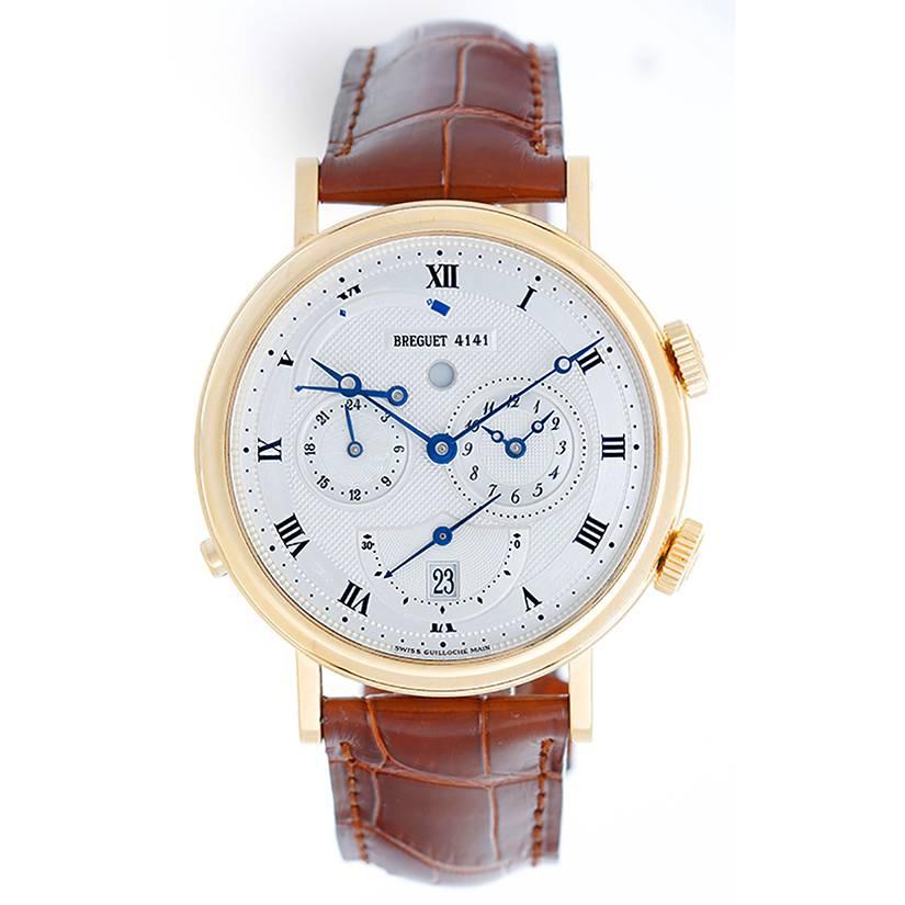 Automatic winding; alarm feature;. 18k yellow gold case with exposition back to view movement (39mm diameter). Silvered white dial with black Roman numerals;  subseconds & date at 6 o'clock position; 24-hour/2nd time zone at 9 o'clock position;