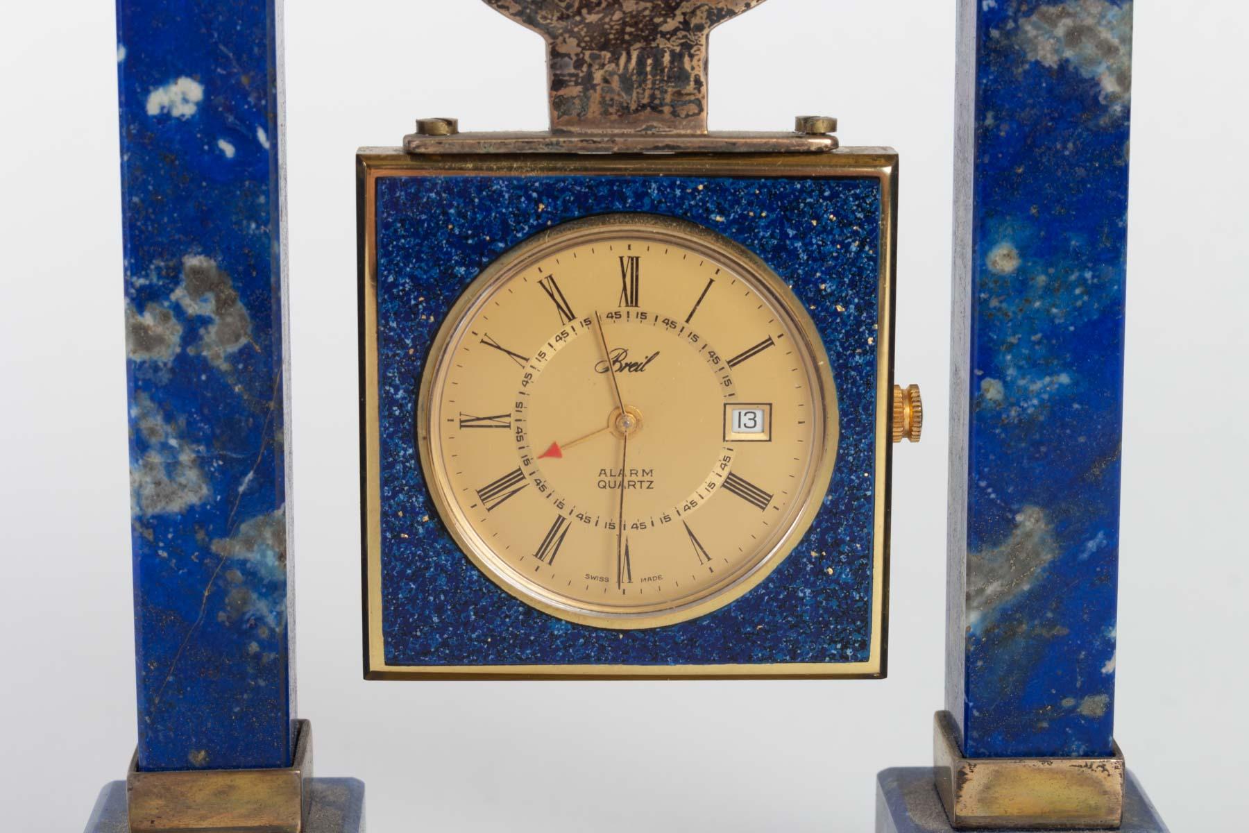 Breil desk clock in lapis lazuli and gilded metal, 20th century.

Measures: H 12 cm, W 11 cm, D 3.5 cm.