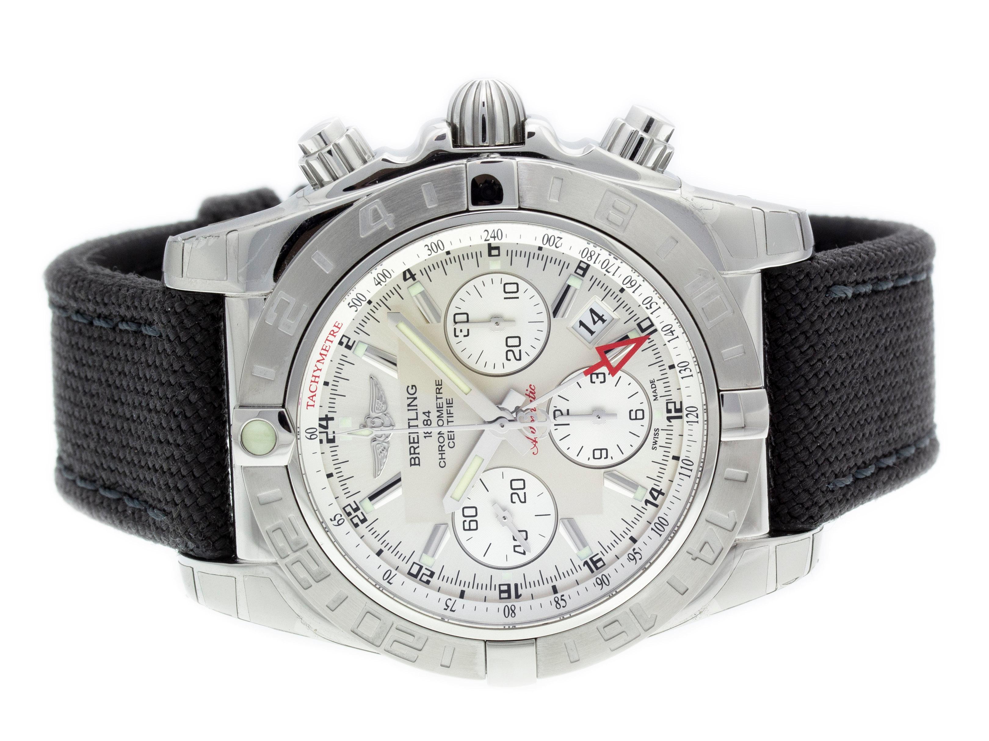 Stainless Steel Breitling Chronomat 44 GMT Automatic Watch with a 44mm Case, Silver Dial, and Military Strap with Tang Buckle. Features include Hours, Minutes, Seconds, Date, and Chronograph. Comes with Gift Box and 2 Year Store