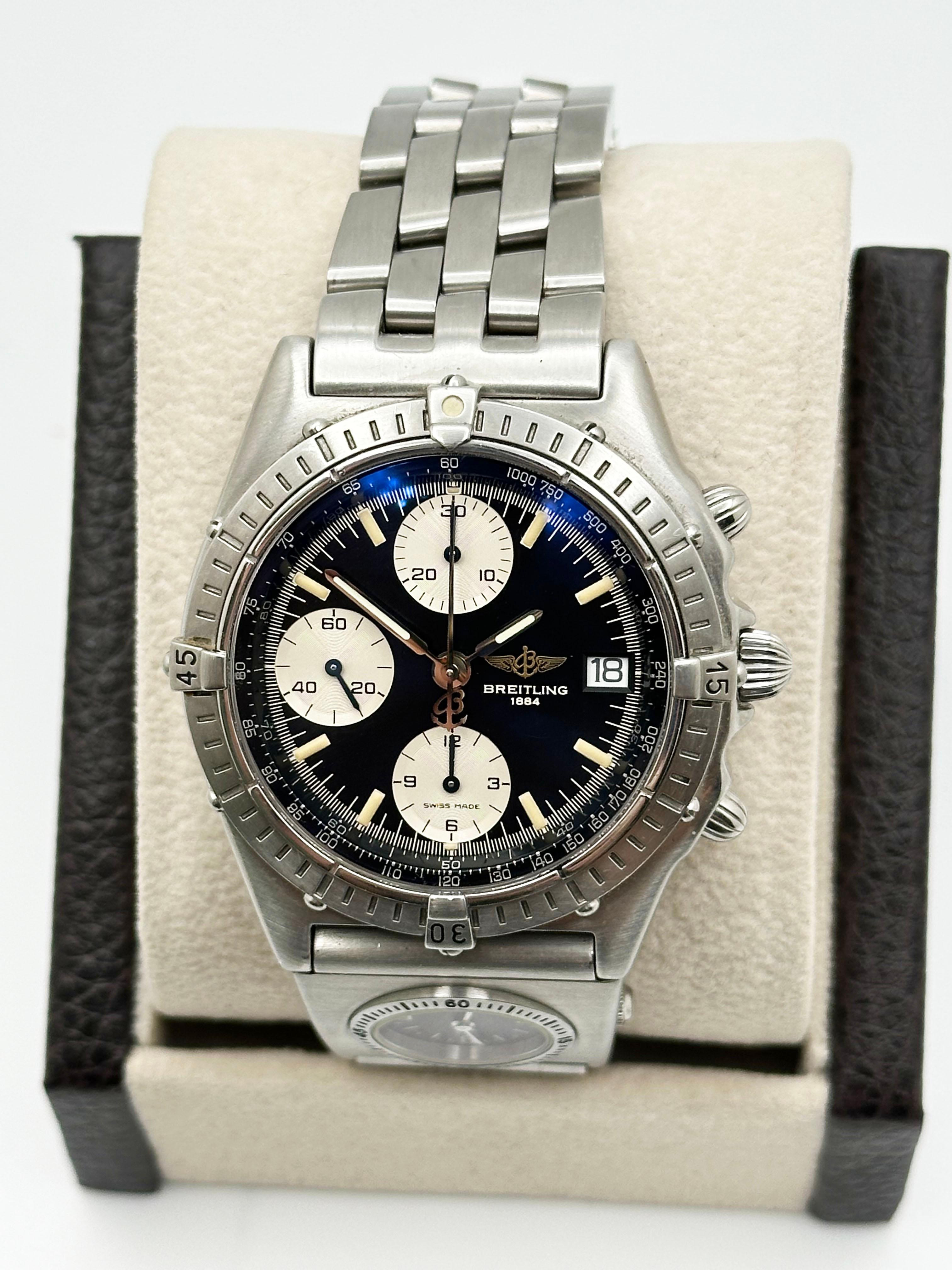 Style Number: A13048

 

Model: Breitling Chronomat 

 

Case Material: Stainless Steel 

 

Band: Stainless Steel with Rare UTC Module

 

Bezel: Stainless Steel 

 

Dial: Black Dial 

 

Face: Sapphire Crystal 

 

Case Size: 39mm 

 

Includes: