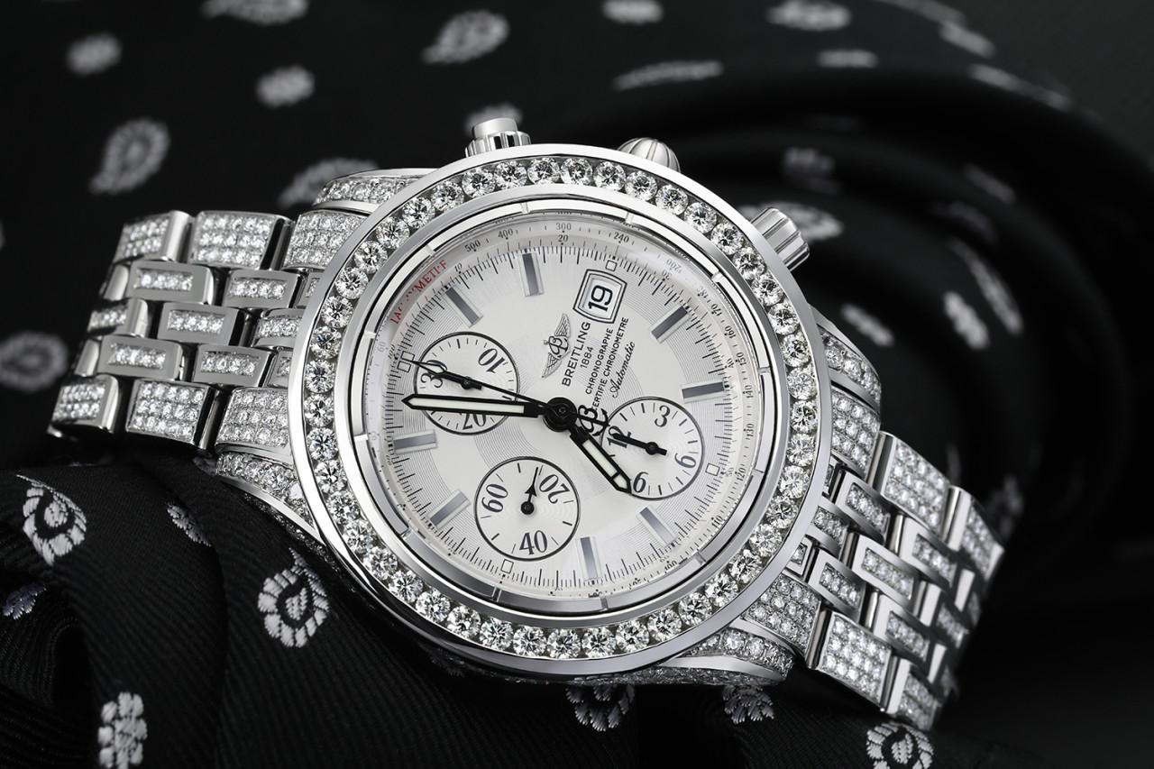 Breitling Chronomat Evolution A13356 Custom Diamond Stainless Steel Watch White Dial A13356

Diamond bracelet, case, and bezel, total of 15ct. Black dial with silver sticks, chronograph, date, and water resistance of over 100m.
This watch is in like