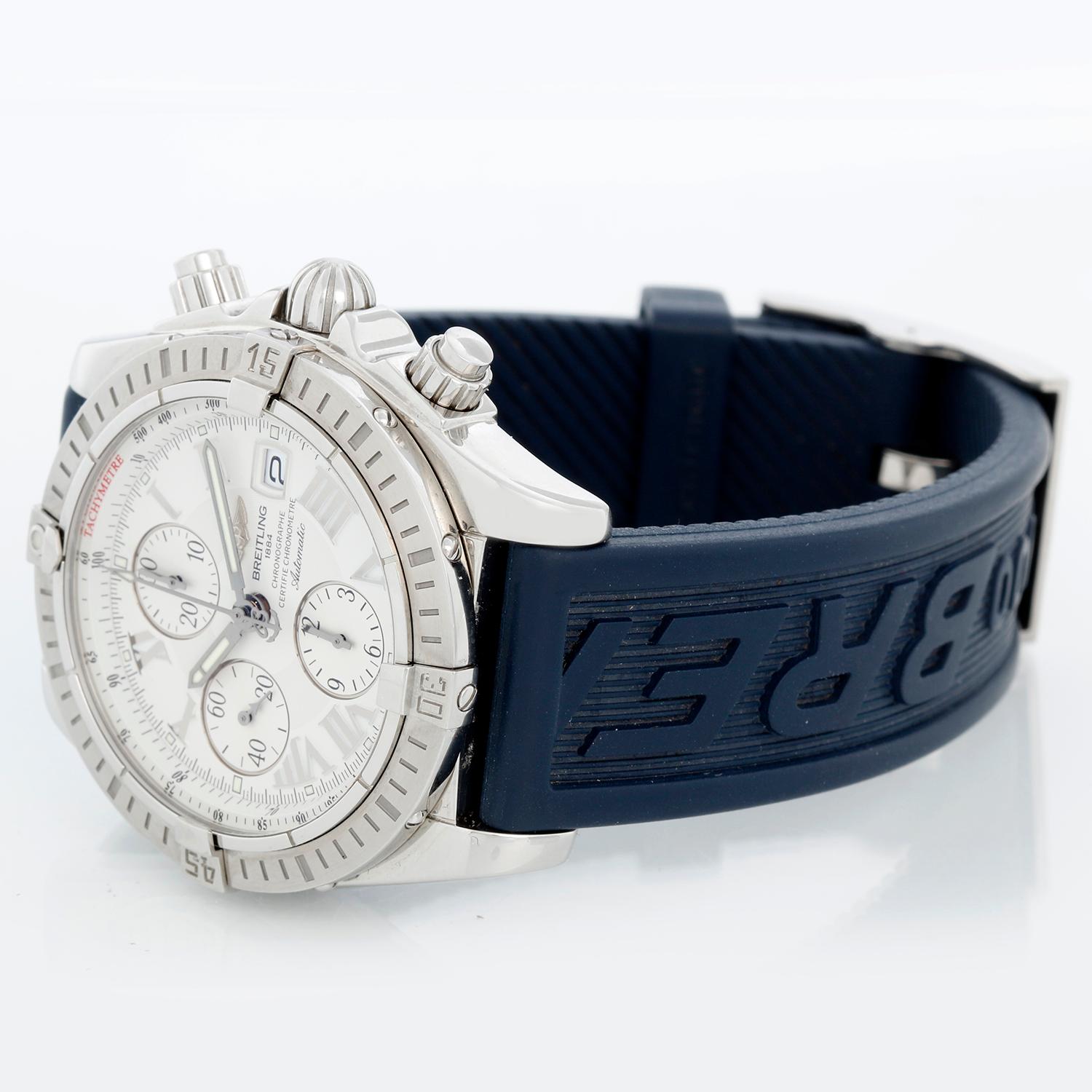 Breitling Chronomat Evolution Men's Watch A13356 - Automatic winding chronograph. Stainless steel case with steel bezel ( 44 mm ). Silver dial with markers; hour minute and seconds recorders; and date. Blue Breitling Rubber strap with buckle.