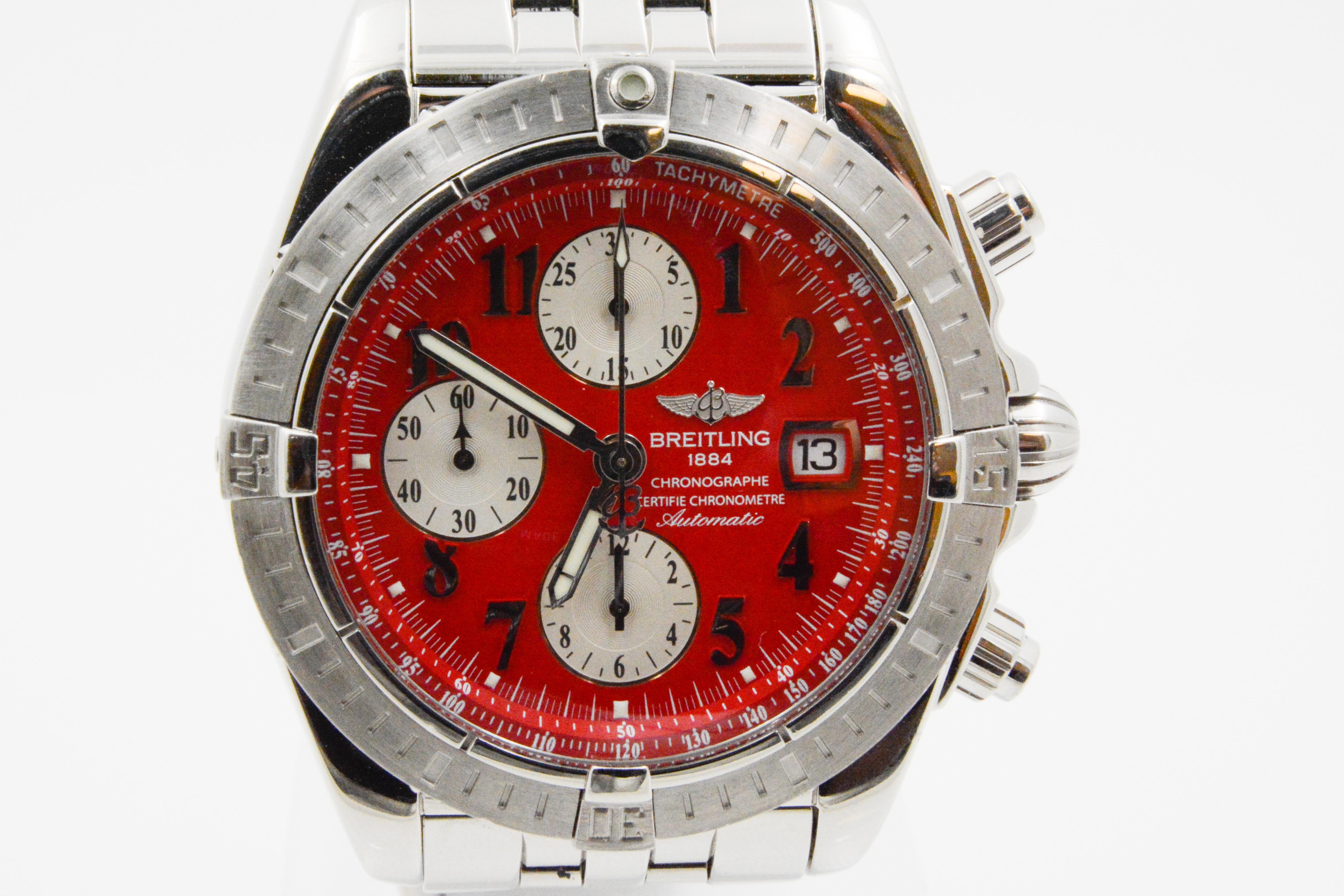 This CPO Breitling Chronomat Evolution steel time piece has automatic movement with a red Arabic dial with silver subs and sapphire crystal. It has a polished steel bracelet.