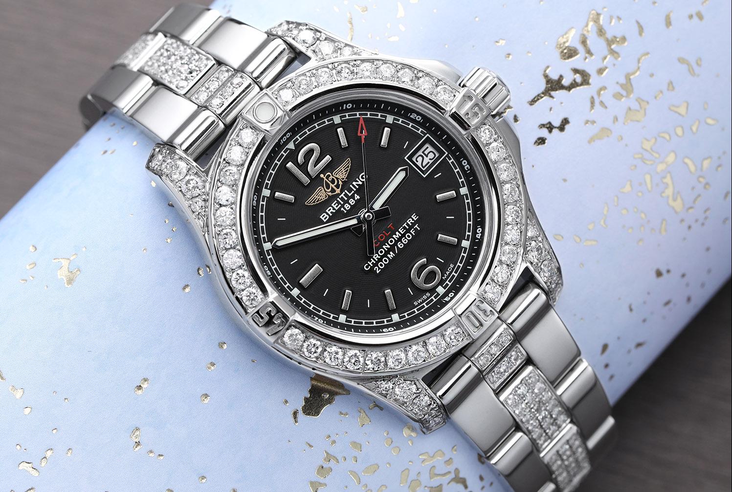Breitling Colt 33 A77388 Black Dial Stainless Steel Ladies Watch with Diamonds. Diamonds are 100% natural, they have been customized aftermarket. Watch comes with a Breitling Box, Papers and an appraisal certificate. Attached to the appraisal is our