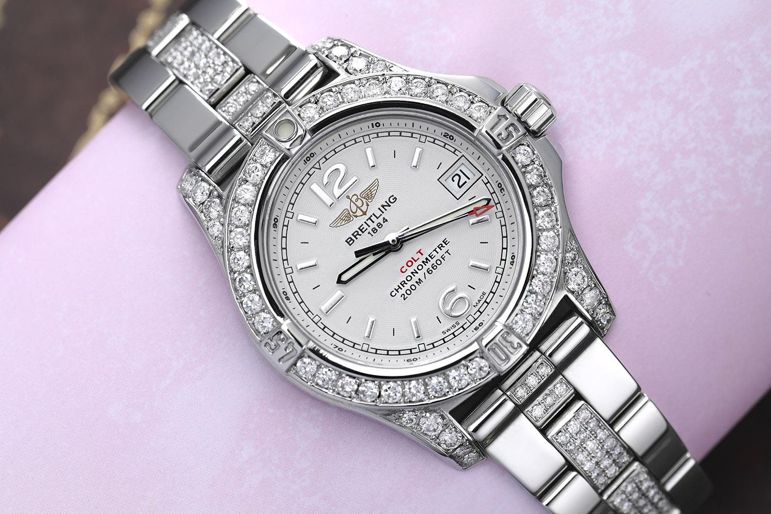 Breitling Colt 33 A77388 White Dial Stainless Steel Ladies Watch with Diamonds. Diamonds are 100% natural, they have been customized aftermarket. Watch comes with a Breitling Box, Papers and an appraisal certificate. Attached to the appraisal is our
