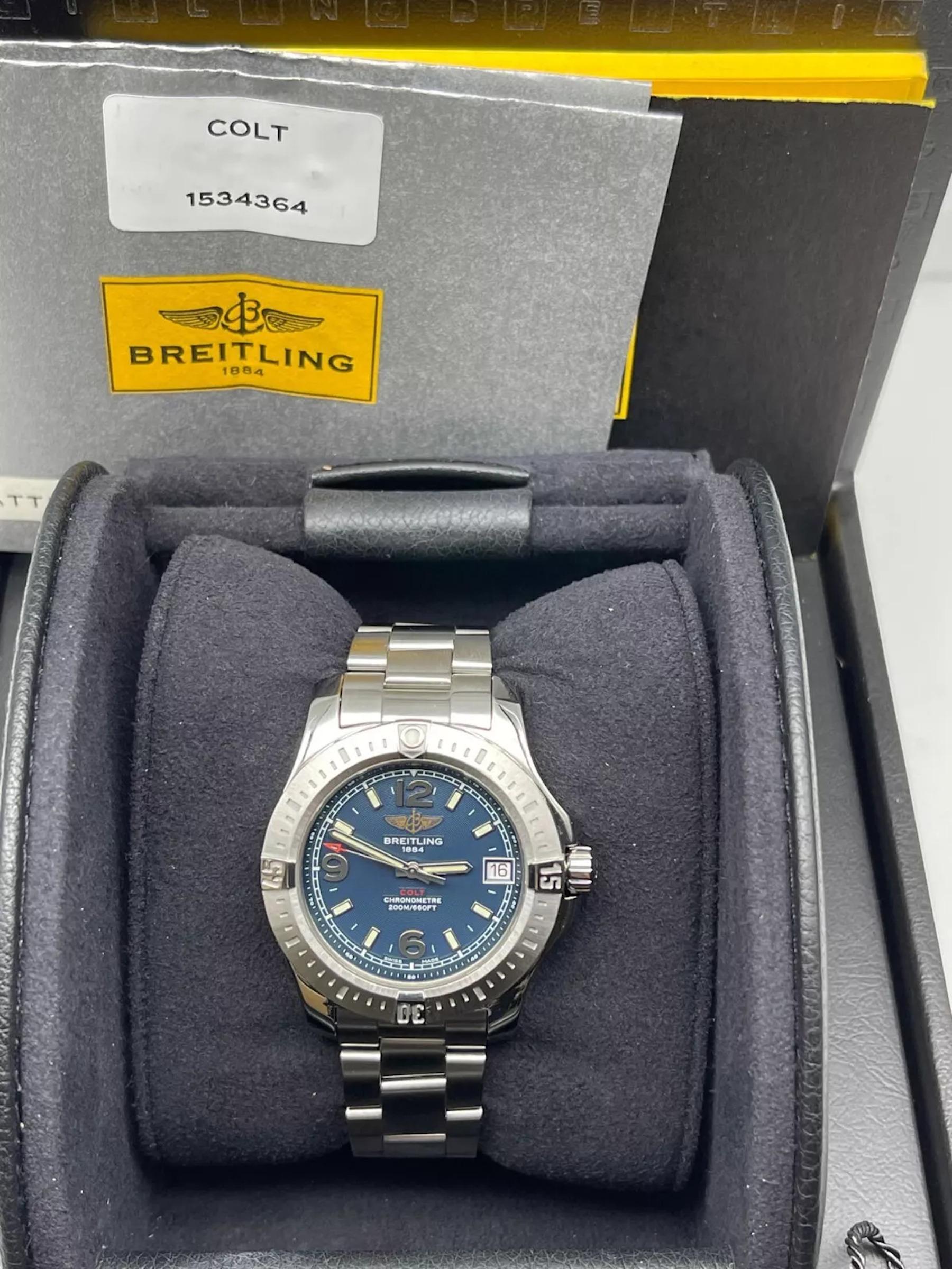 Style Number: A74389
Model: Breitling Colt
Case Material: Stainless Steel
Band: Stainless Steel
Bezel:  Stainless Steel
Dial: Blue 
Face: Sapphire Crystal 
Case Size: 36mm 
Includes: 
-Breitling Box & Booklet
-Certified Appraisal 
-1 Year
