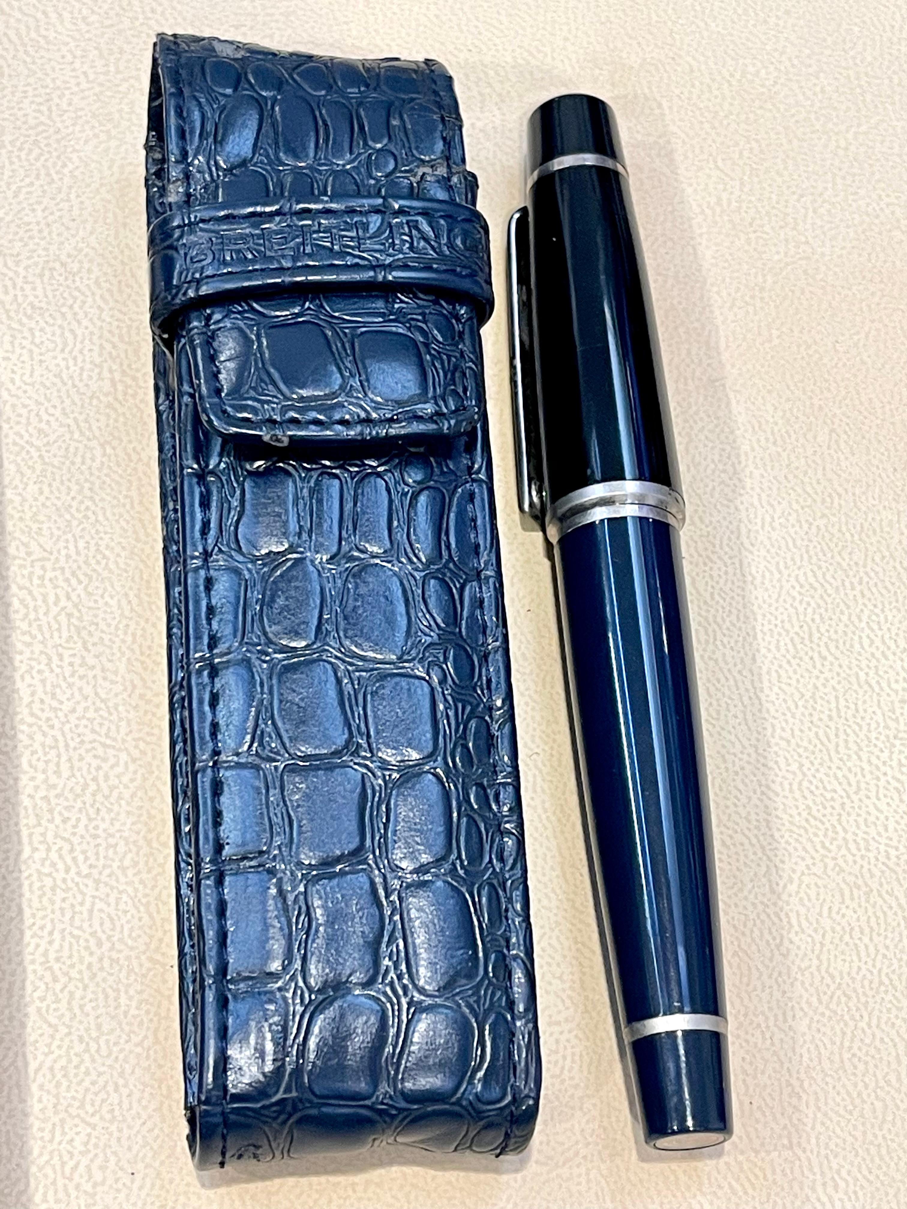 100 % authentic and Vintage 
Nice smooth Working Condition
BREITLING Genuine Ballpoint Pen Black And Silver With Leather Case
Luxurious Breitling Black Glossy Barrel With Stainless Steel Trim.  
Features the iconic 