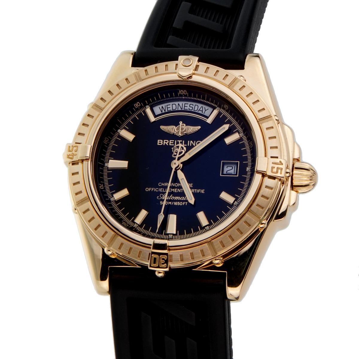 A certified authentic Breitling 18k yellow gold watch featuring a black dial, sports diver black strap, sapphire crystal, unidirectional bezel, with an 18k gold tang buckle. The watch measures 44mm.