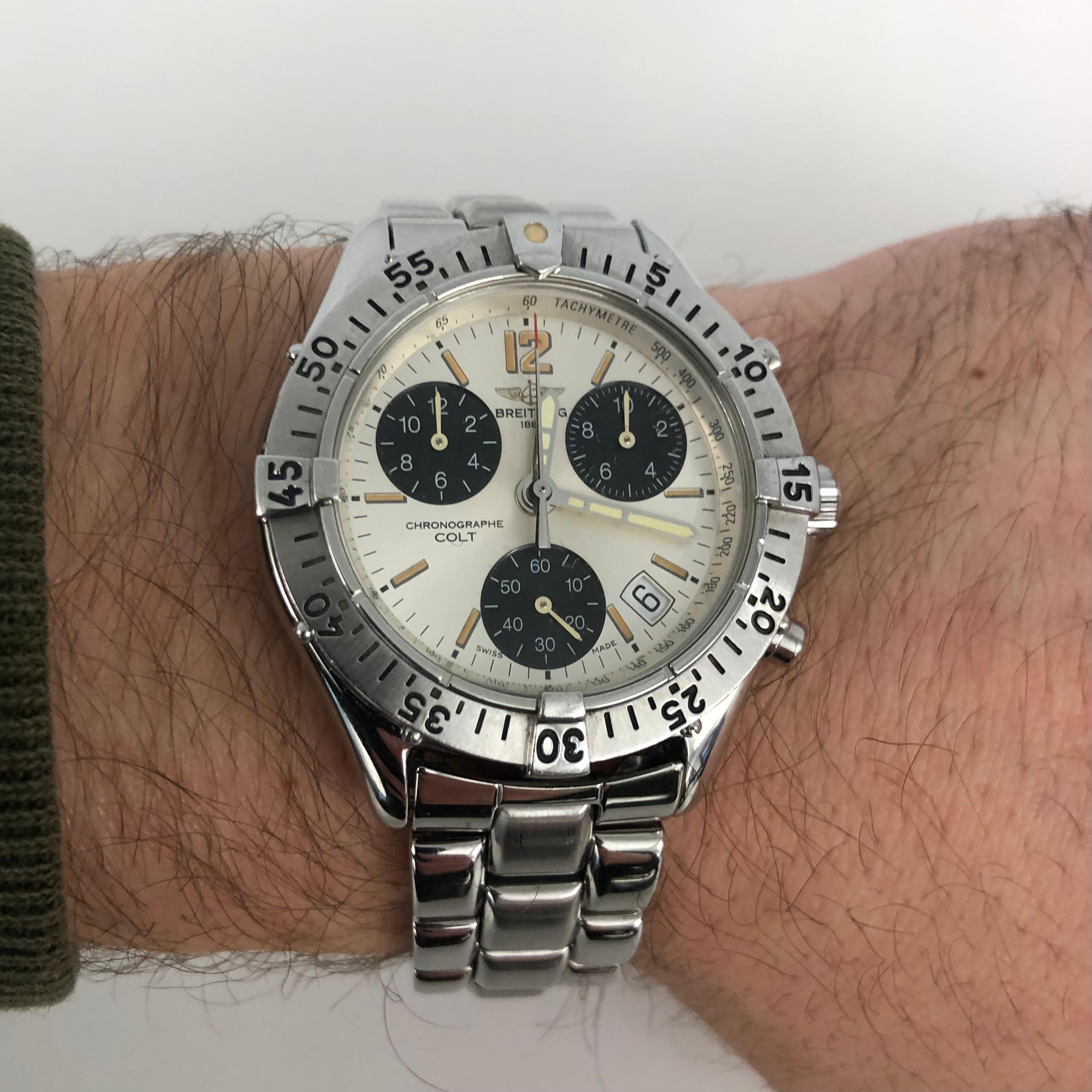 Breitling Colt Chronograph Stainless Steel White Dial Watch A53035.

This 38mm Breitling timepiece features a stainless steel case with a unidirectional rotating bezel and a stainless steel bracelet with folding deployment clasp and safety buckle. A