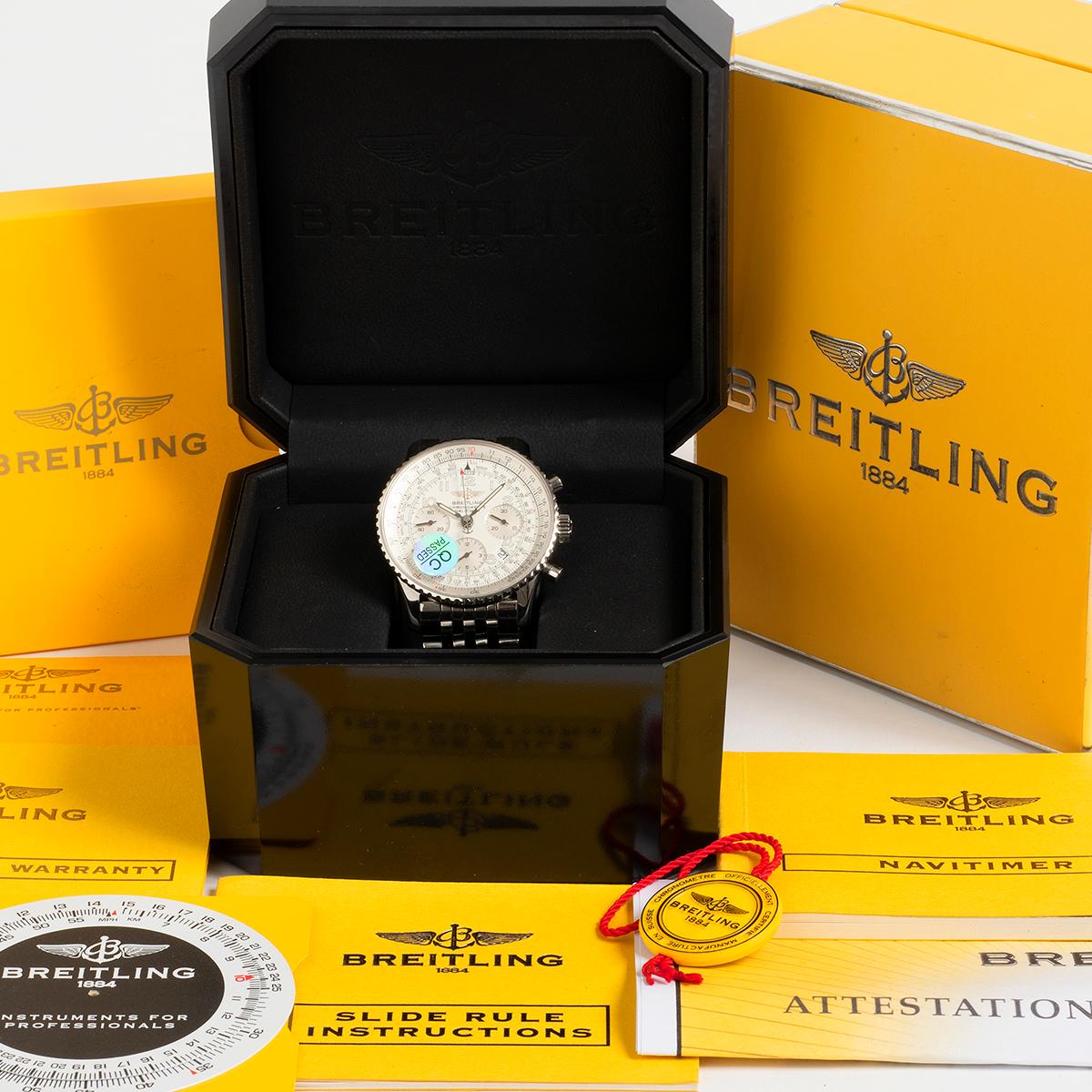 Our Breitling Navitimer chronograph with date features a stainless steel 42mm case with white dial and stainless steel bracelet. A complete set, unworn since a £935 full Breitling service in 2020, this comprises inner and outer box, slide