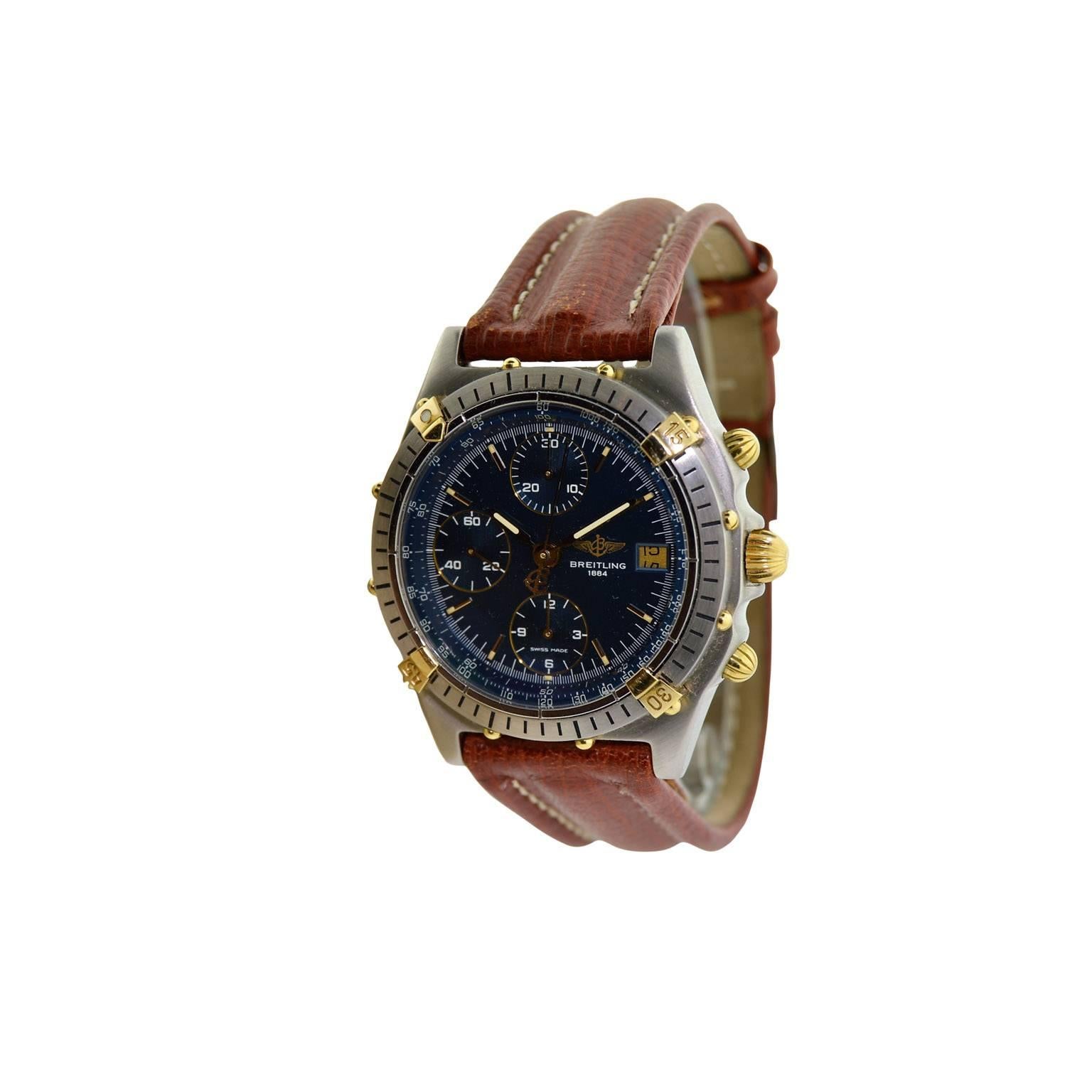 FACTORY / HOUSE: Breitling Watch Company
STYLE / REFERENCE:  Chronomat / 81.950
METAL / MATERIAL: 18Kt. Gold and Steel
CIRCA: 1990's
DIMENSIONS: 39mm X 39mm
MOVEMENT / CALIBER: Automatic Winding / 25 Jewels 
DIAL / HANDS: Original Blue / Steel Baton