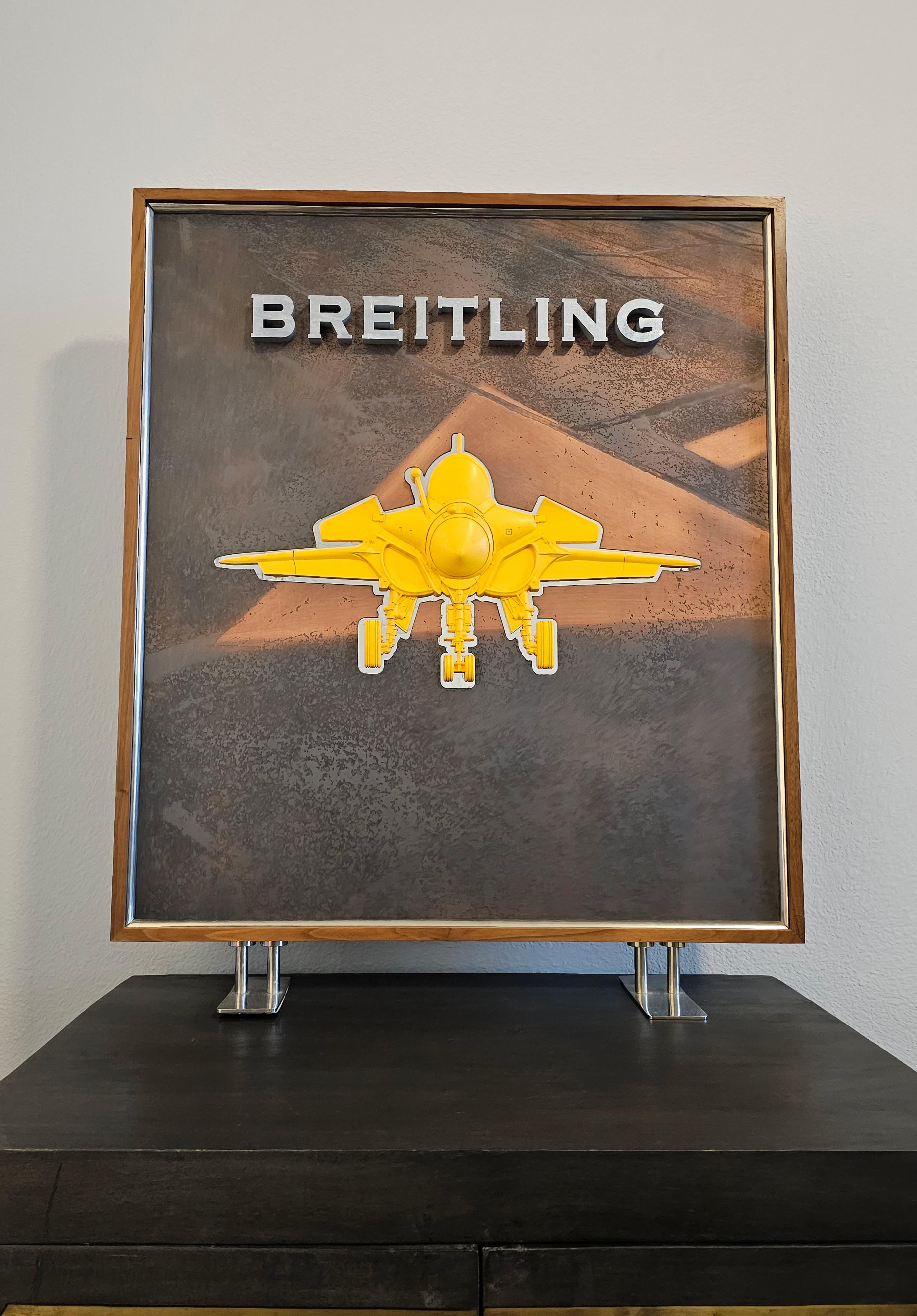 A scarce vintage Breitling watch three-dimensional retail store advertising display stand window sign. 

Rare large free-standing example, only given to select dealers, featuring a tall rectangular solid wood frame, raised chrome Breitling letters,