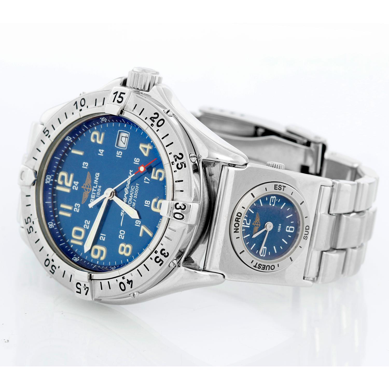 Breitling SuperOcean A17040 With UTC Modul A61172 - Automatic. Steel case ( 41mm). Blue dial with luminous Arabic numerals. Stainless steel bracelet with Breitling UTC modul clock a61172; Fits a 7 1/4 inch wrist . Pre-owned with Breitling box and