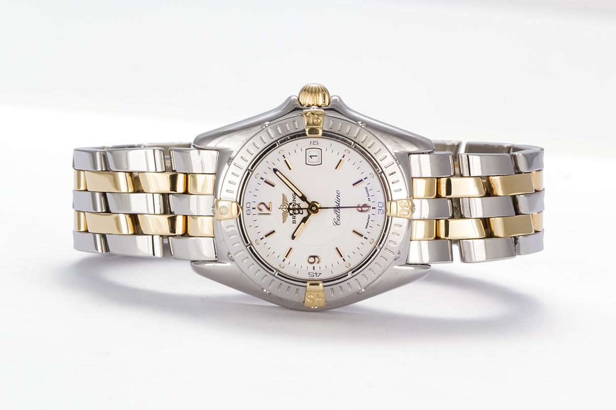 We are pleased to offer this Breitling Callistino Watch B52045. This watch features a solid 18k yellow gold and stainless steel two tone design with a quartz movement and white dial. the case is 32mm and the watch will fit a wrist up to 6