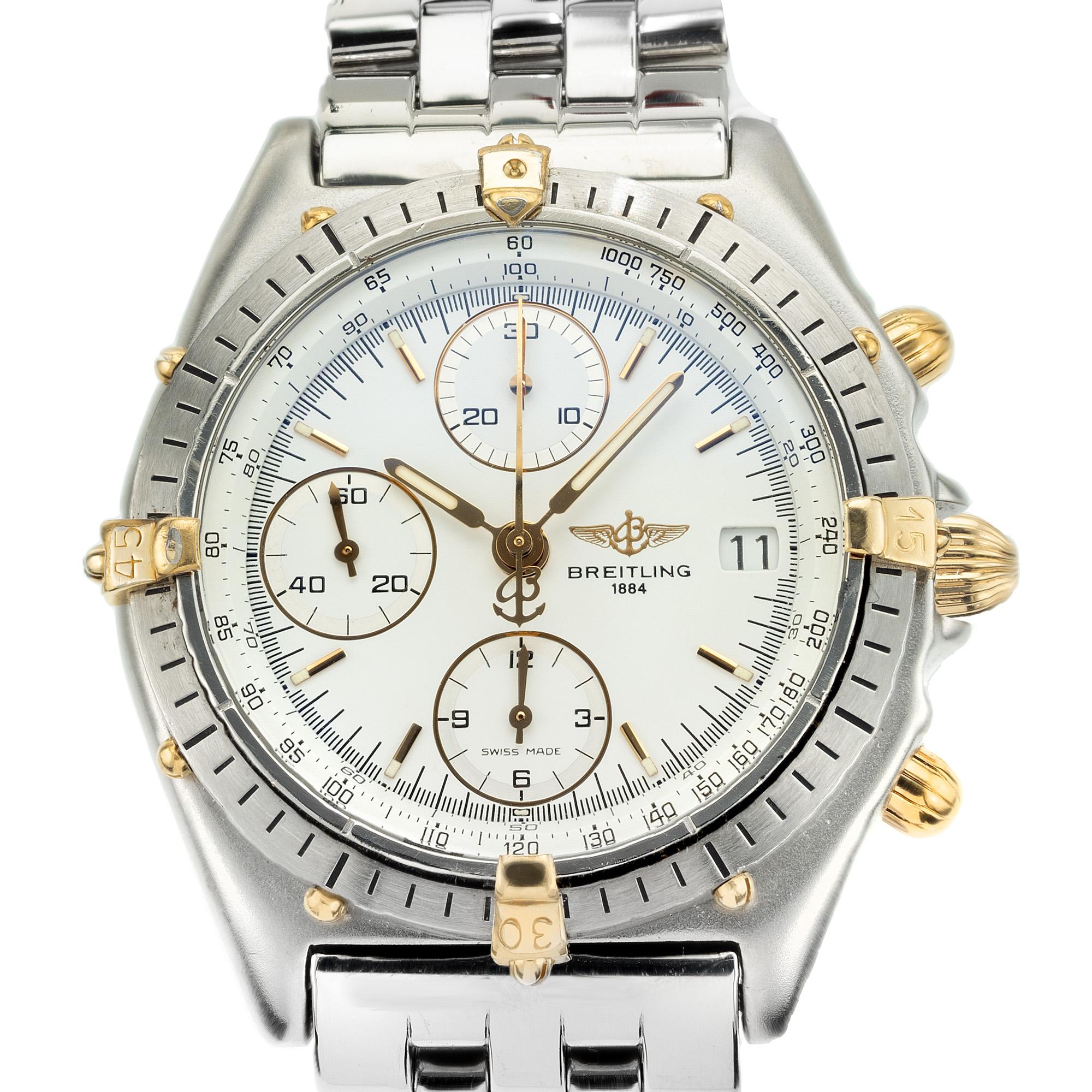 1990's Breitling chronograph with crisp white round dial. 1990's Breitling 18k yellow gold and steel chronograph wristwatch is a true masterpiece in the world of luxury timepieces. This exquisite watch is a harmonious blend of white gold and steel.