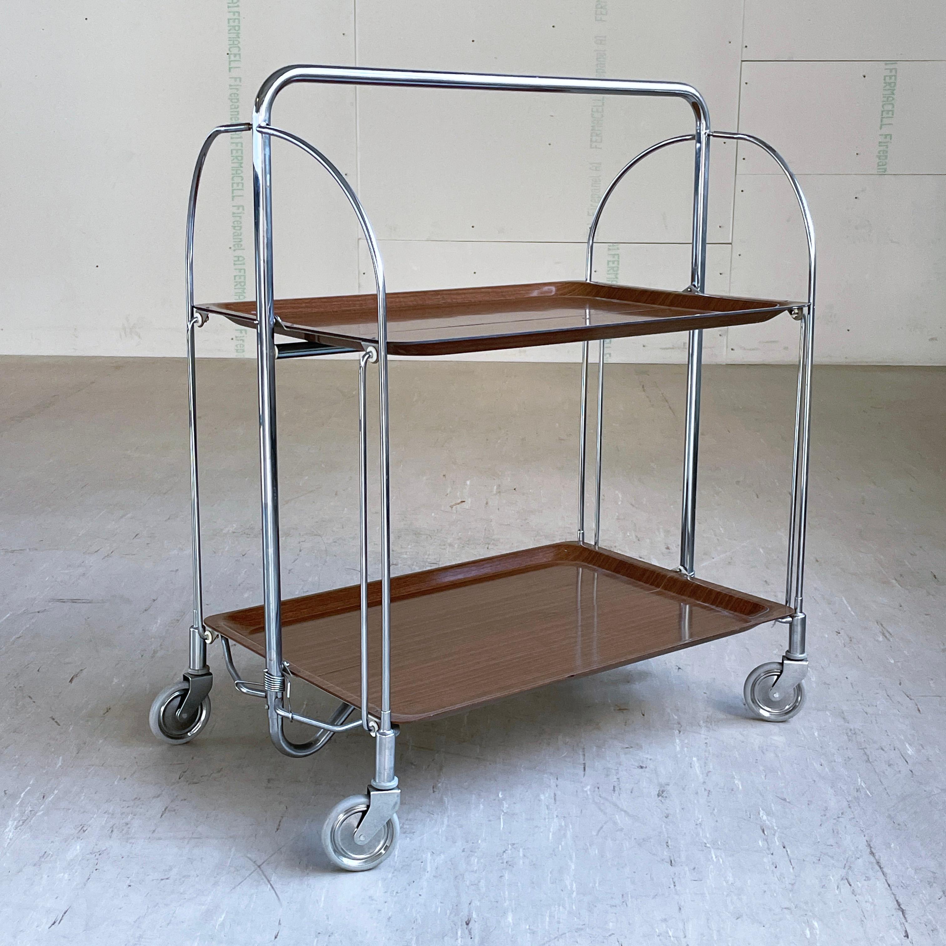 Bremshey & Co. Dinette Chromed steel folding frame with wood effect Formica surface. Practical for easy storage and occasional usage.
Producer: Bremshey & Co. (Bremshey Gerlinol ) Germany 1970 - 1979
Measurements: Height: 78 cm  Width: 68 cm  Depth