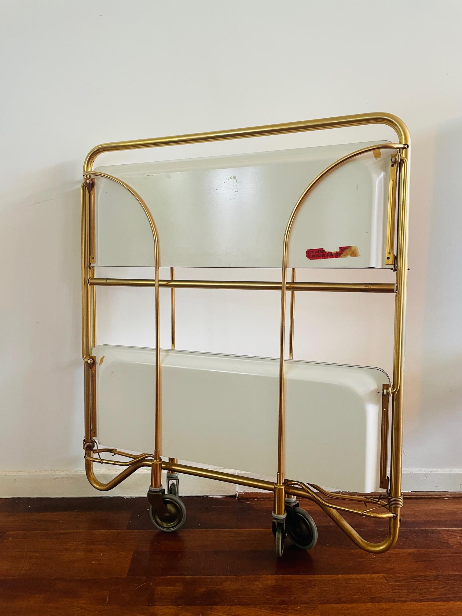 Mobile bar, manufactured by Bremshey & Co in Germany, 1960s,
It is characterized by a synthetic form, application (after assembling one part it can be used as, for example, a shelf)
This brass version of the Bremshey serving card in combination with