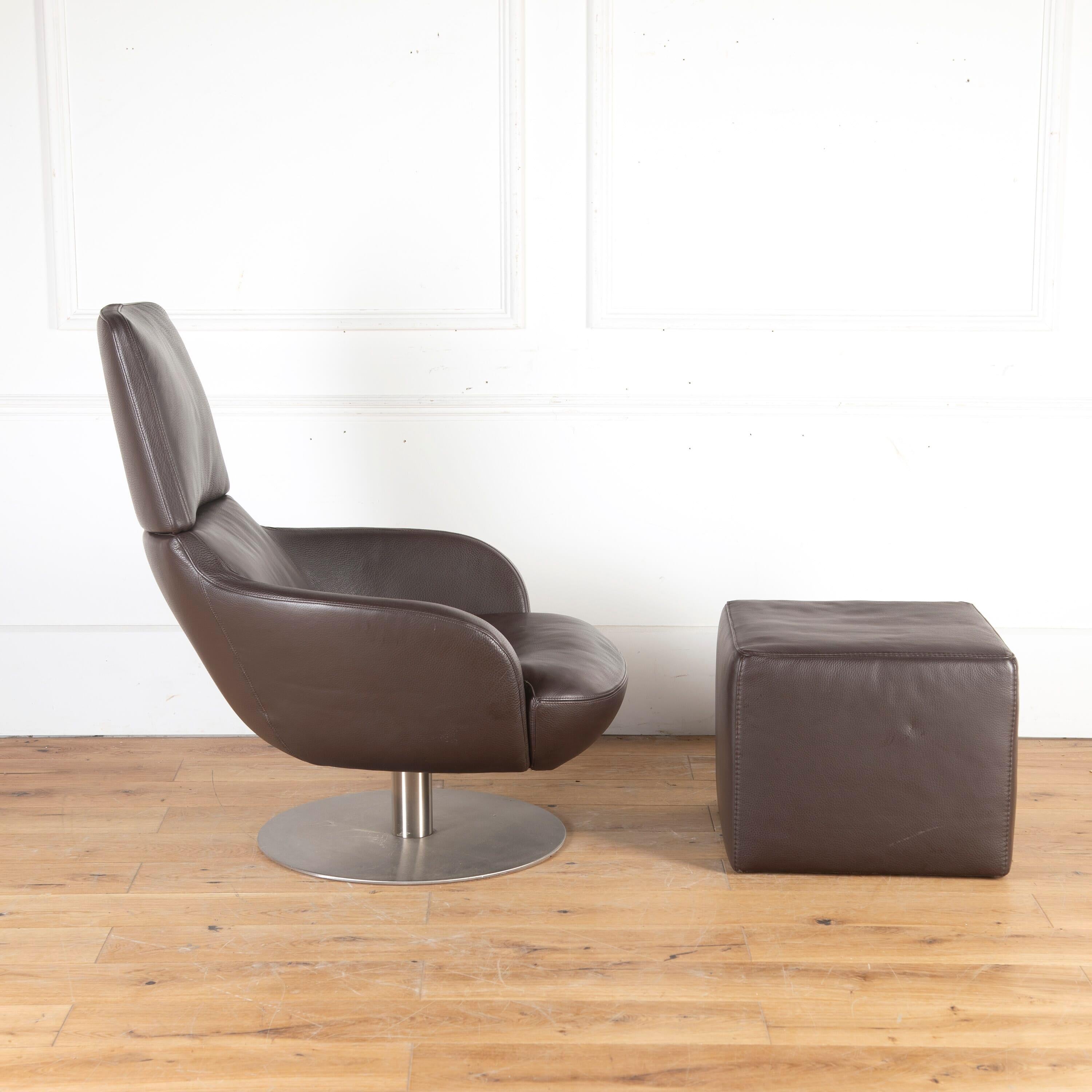'BREND' Italian leather swivel armchair with matching footstool. By Pasquale Natuzzi Italia.

This stylish set is comprised of a sleek armchair with a gently reclined back and enclosed sides, covered in chocolate brown leather. Resting on a flat