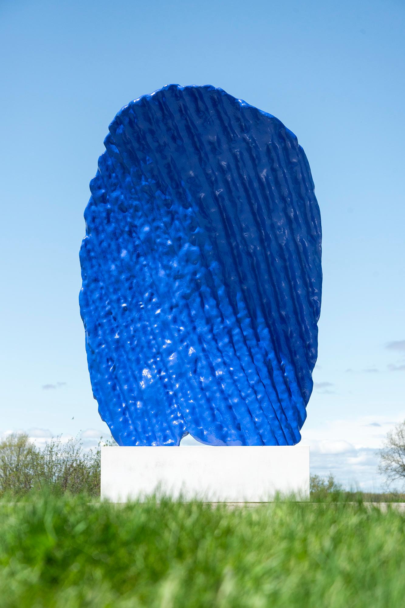 This contemporary monumental blue-colored sculpture is by Brendon McNaughton.

The distinctive visual language of this multi-disciplinary Canadian artist has attracted the attention of numerous international collectors. McNaughton’s ethos is to