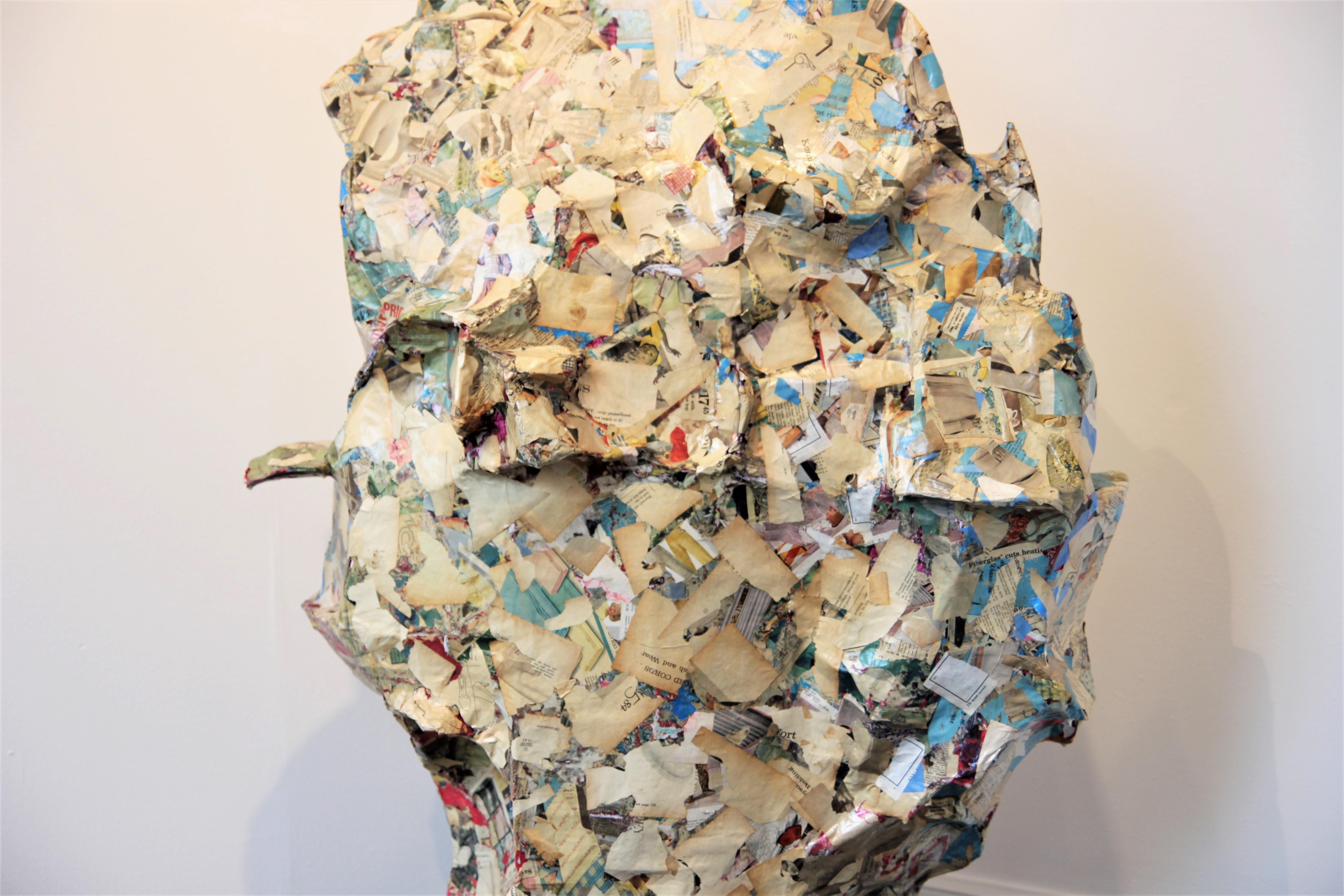 Colorful abstract contemporary collage sculpture that incorporates pages from 1960 Sears catalogues, cardboard, wood, concrete, acrylic paint, and wood glue. The organic, amorphous form features a primarily cream surface with accents of bright blues