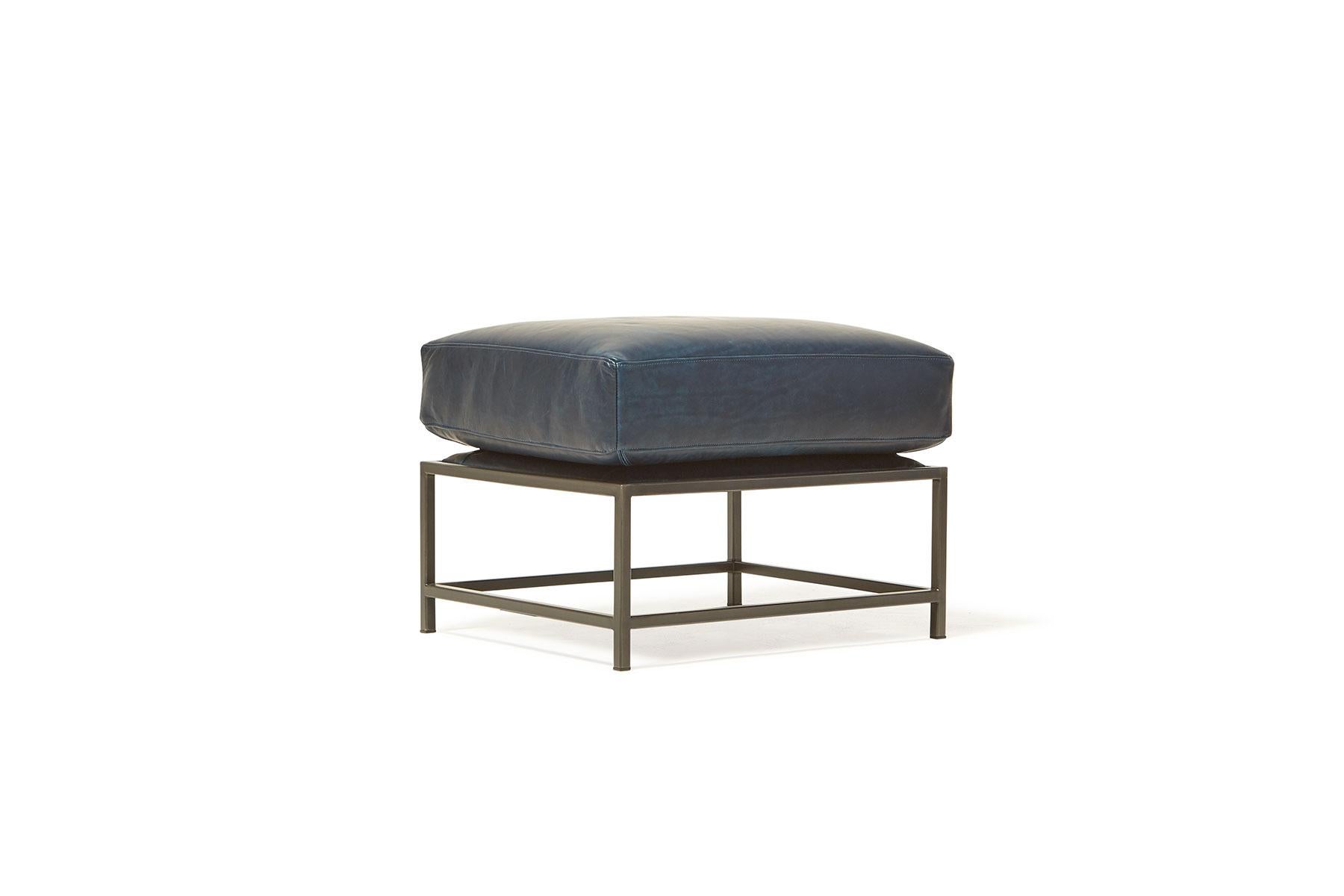 Designed to pair with any of the Inheritance Seating options, the Ottoman is a great addition to add a lounge element to your seating arrangement. 

This variation is upholstered in Brentwood Navy leather by Moore & Giles. Sitting atop a blackened