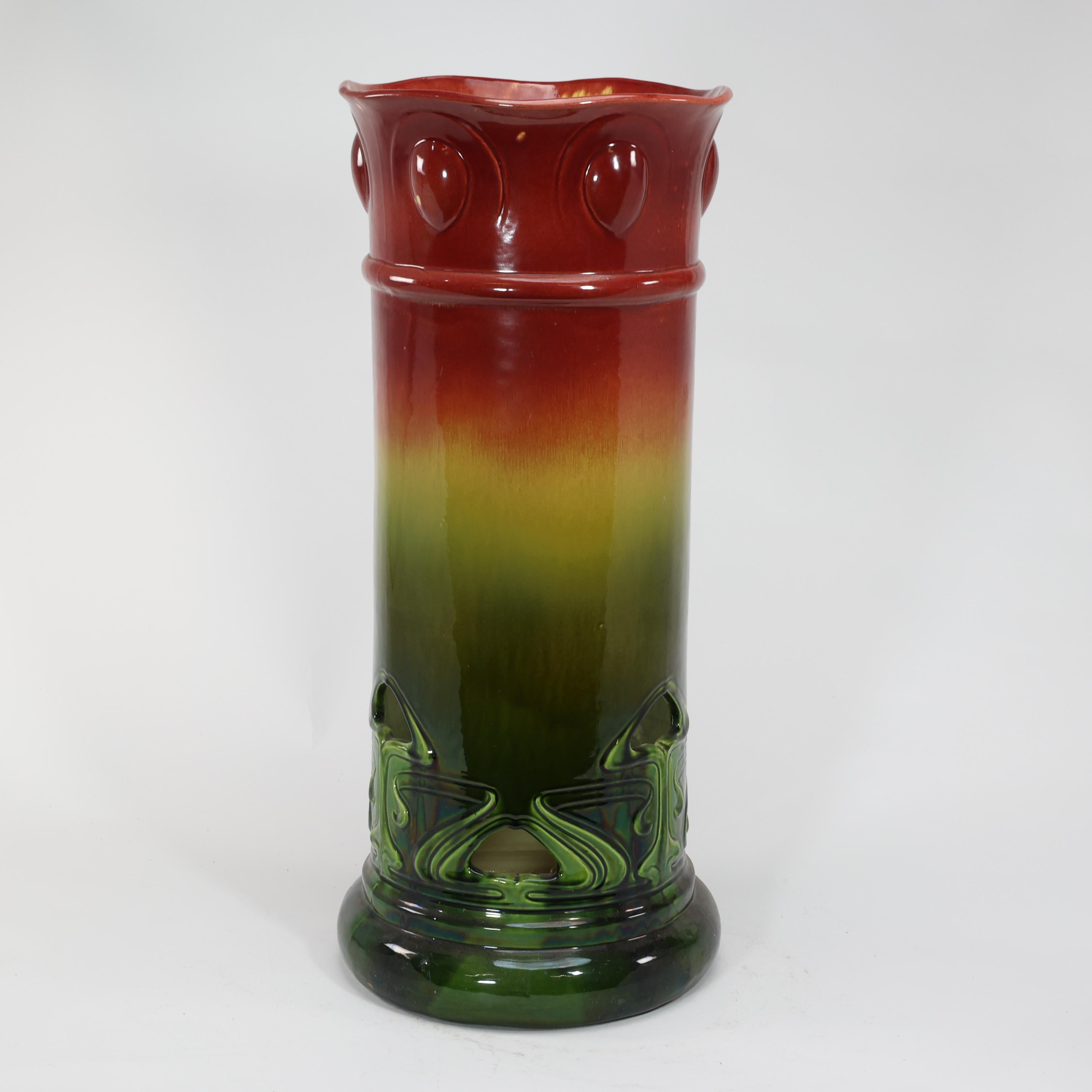 Bretby Art pottery. An Arts and Crafts red and green umbrella and walking stick stand with floral decoration pierced to the base to allow rainwater to dry quickly.