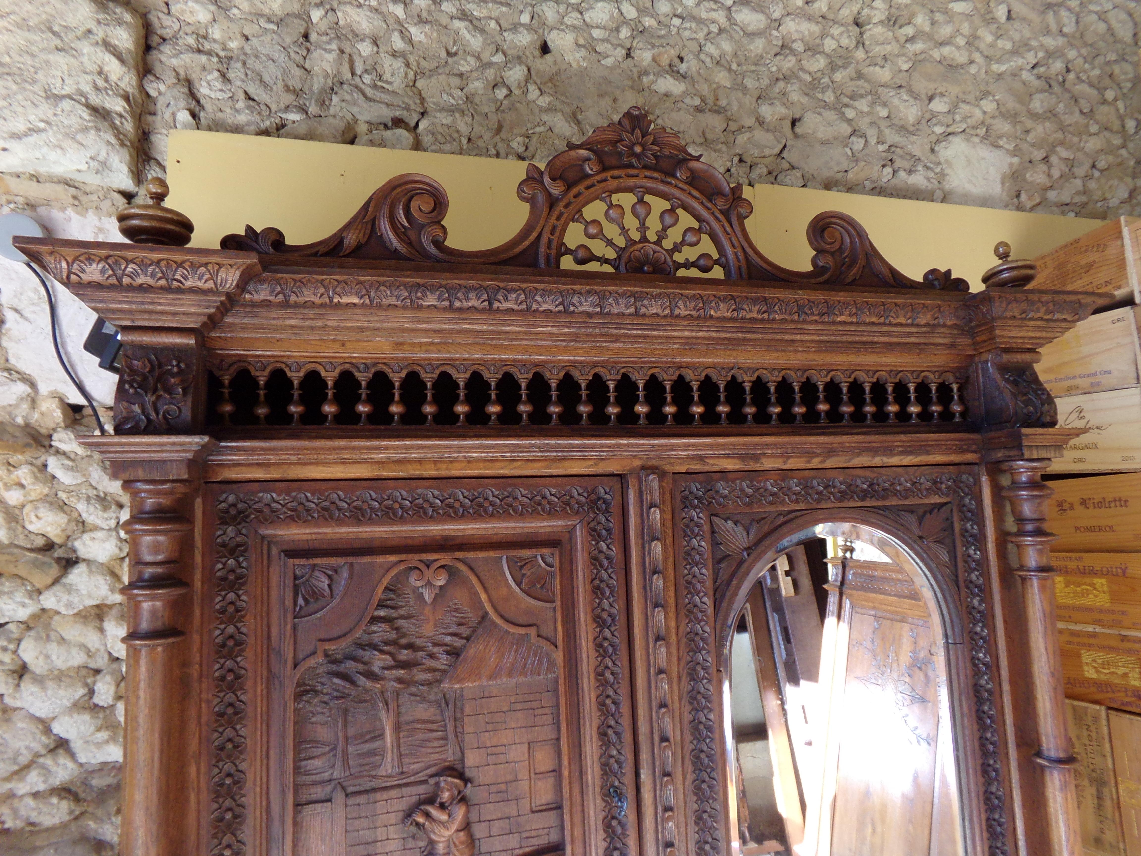 A rare opportunity to own an outstanding carved Breton Oak Compendium Armoire Signed by Louis-Mari Lepeutrec the famous Breton Ebaniste and sculpture. This Fine piece combines fully adjustable shelves, which can be lifted out to provide hanging