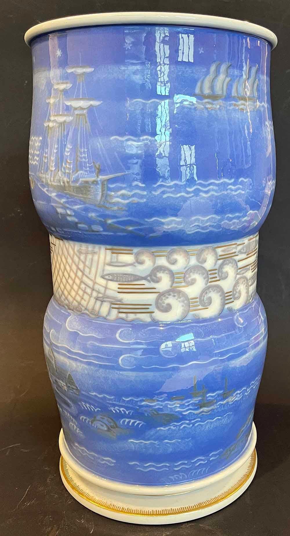 One of the finest pieces of Art Deco porcelain we have ever seen, and probably the greatest work ever executed by Adrien Leduc for Sevres, this large double-gourd vase depicts in great detail scenes from the life of a Breton village along the sea.