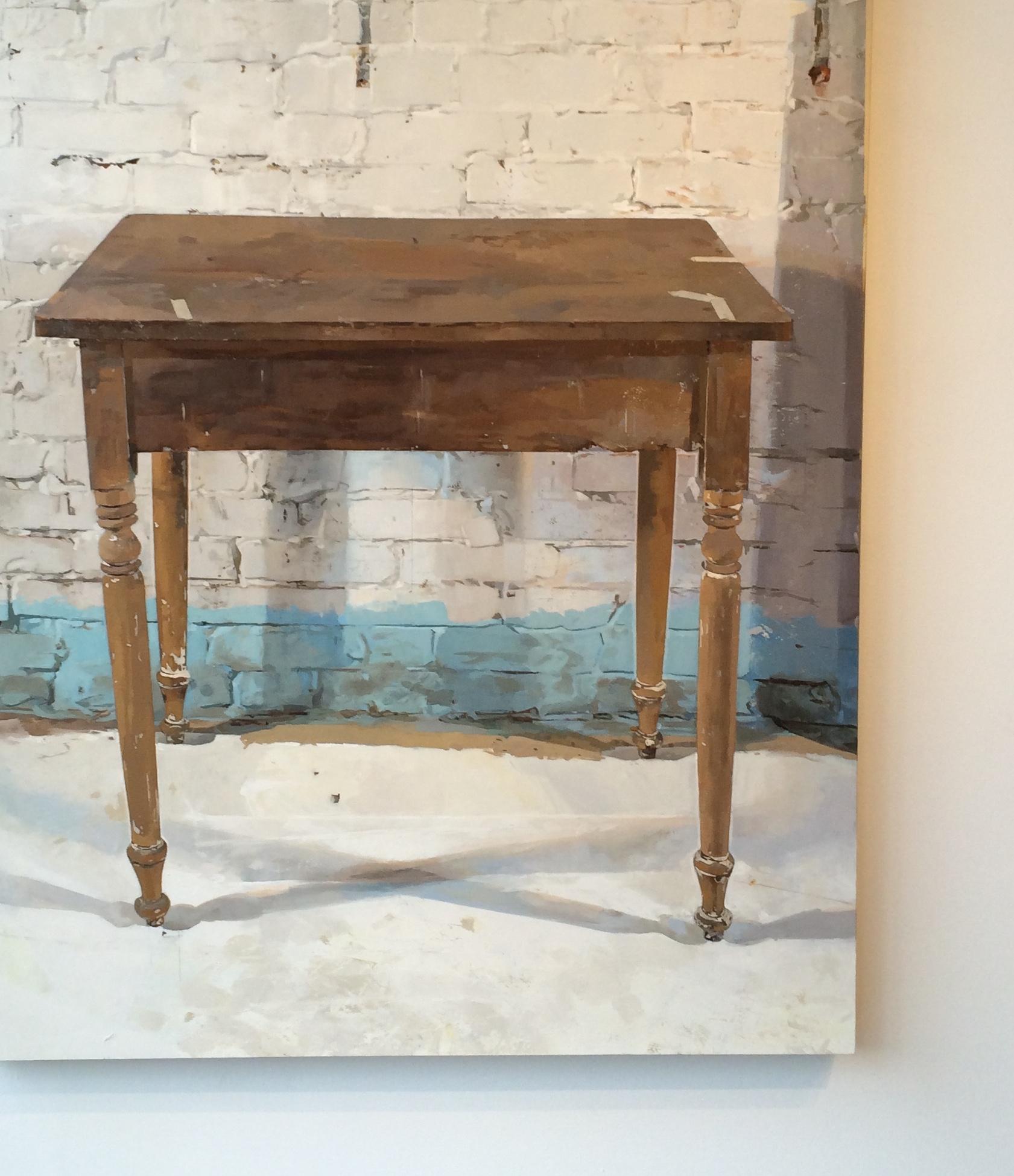 A single wooden table stands against a white brick wall. The solitary piece of furniture is unexpectedly dramatic; a subtle shadow is cast by its legs on the white floor and on the wall behind it. Signed, dated and titled on verso.

Brett