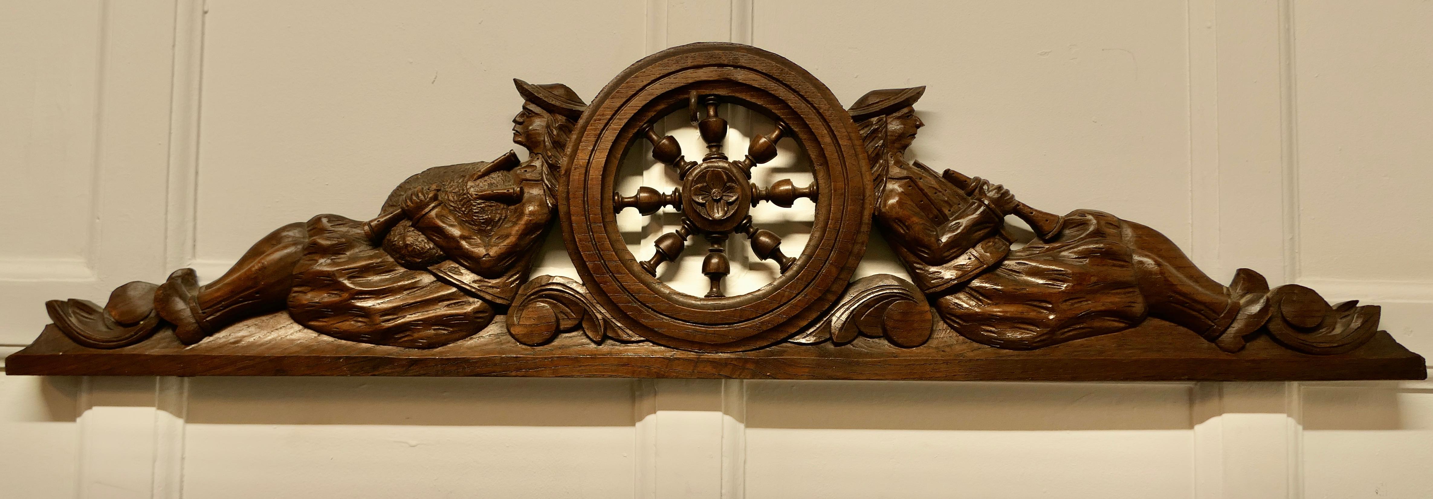 Bretton carved oak decorative pediment, over door 

A lovely carved oak Pediment from an item of French Furniture 
This piece is very much in the Bretton style showing 2 very relaxed musicians resting on the wheel of life 
The cornice would work