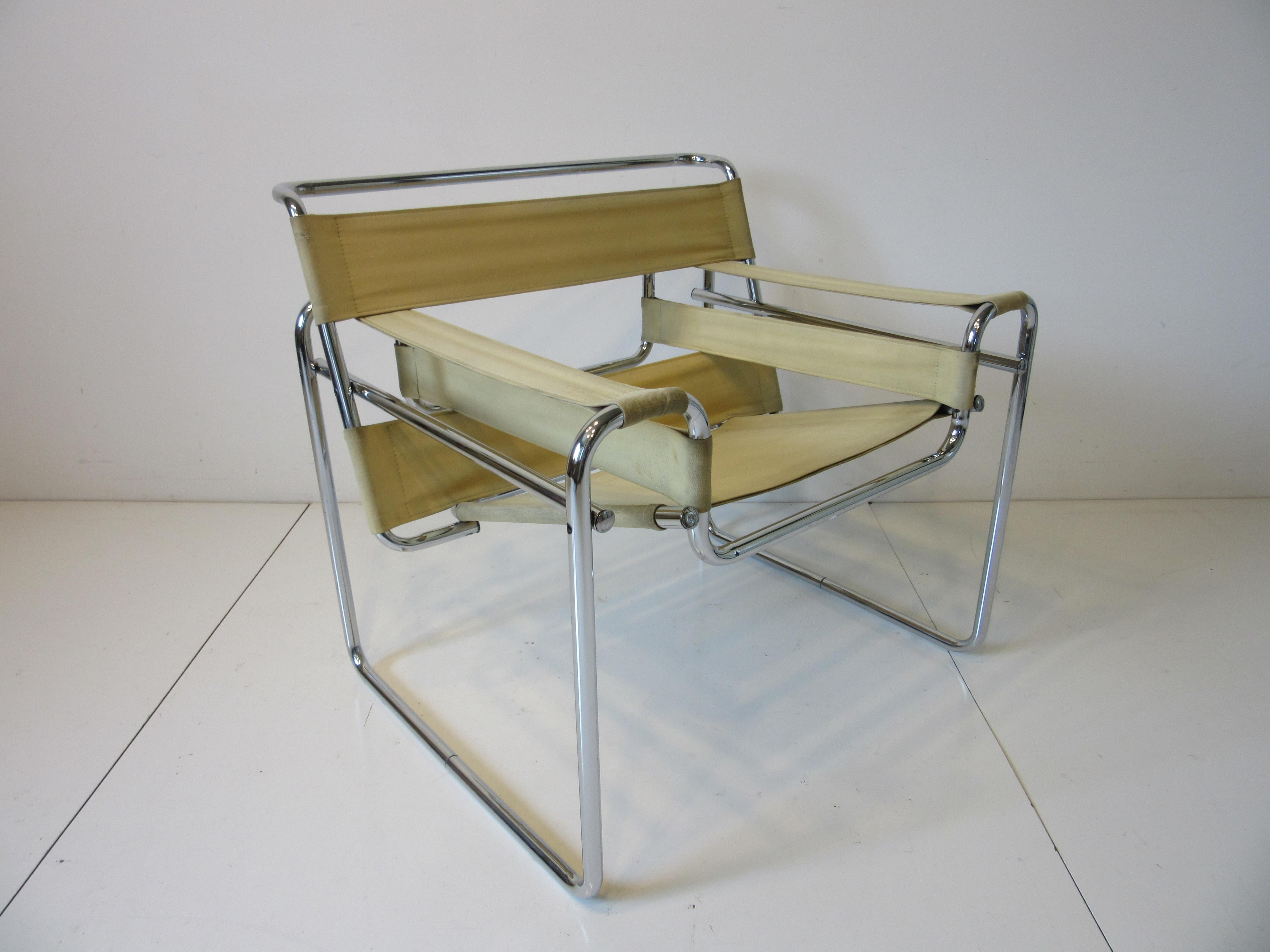 A hard to find canvas slung Wassily lounge chair with sculptural steel chromed frame by Marcel Breuer finished in a yellowish canvas material. Model # B3 designed in the late 1930's this iconic chair is still as fresh then as it is today.
